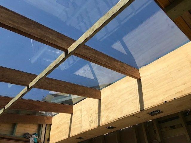 Wooden Beams and Plywood Frame a Clear Skylight — Master Glass & Glazing in Newcastle, NSW
