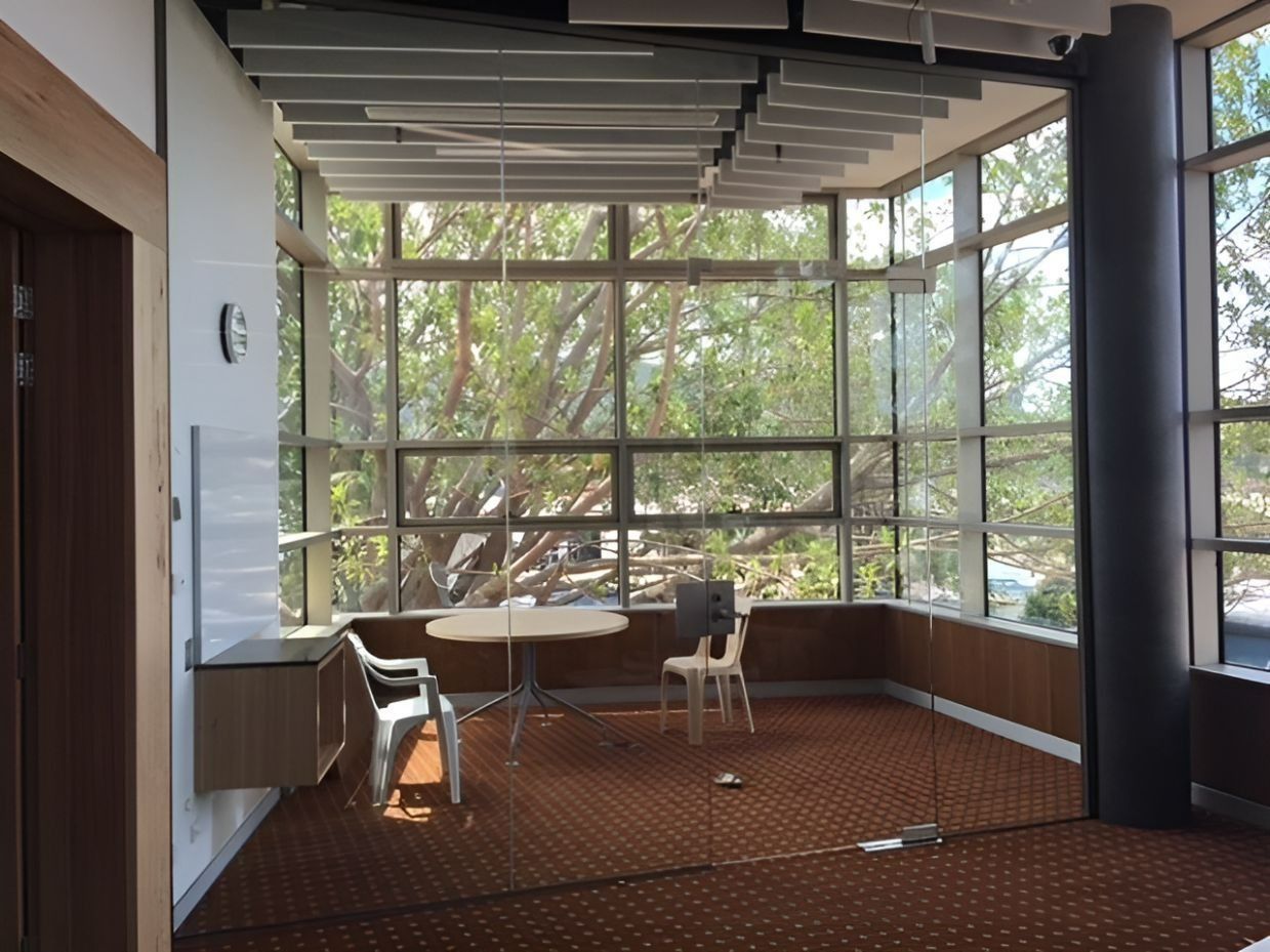 Interior Room with Large Windows, Brown Carpet, Small Table, and Two Chairs — Master Glass & Glazing in Newcastle, NSW