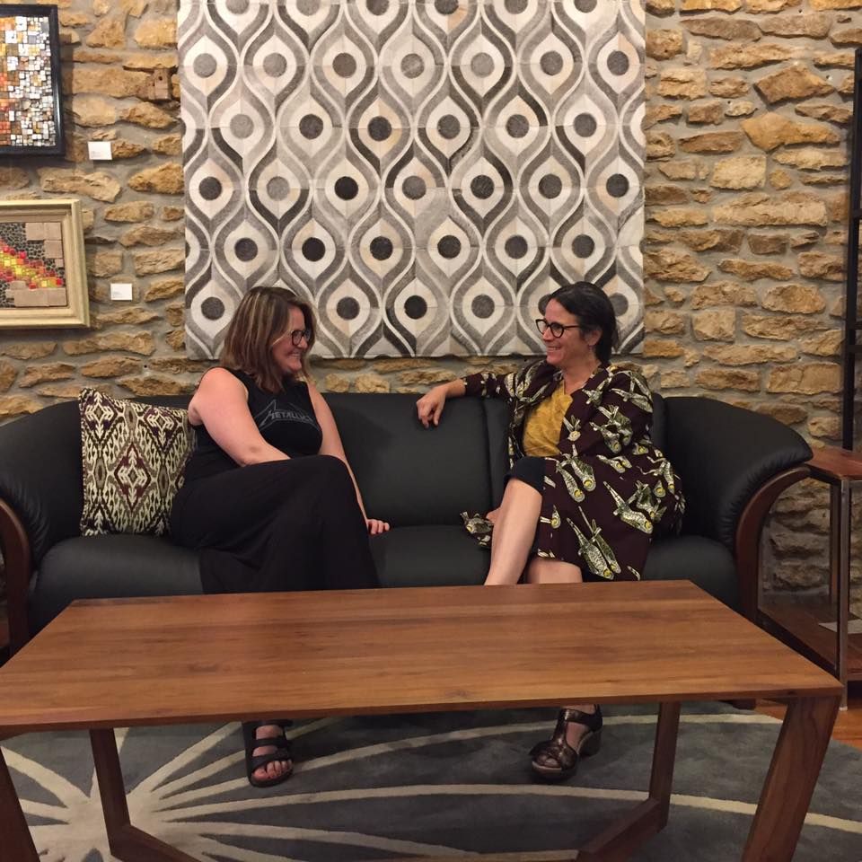 Two people sitting in Eagles' Rest Natural Mattresses and Furniture inLawrence, Kansas. 