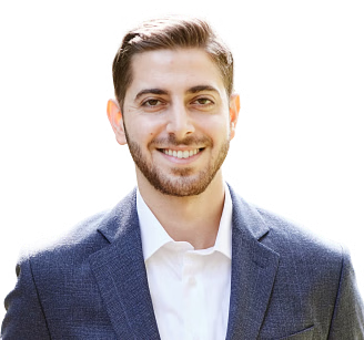 Man in blue blazer and white shirt smiling.