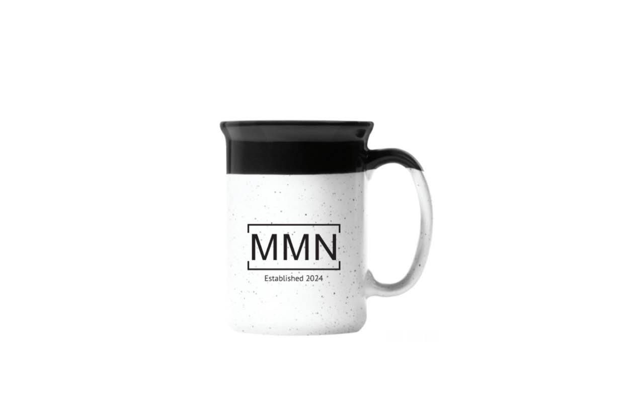 White speckled coffee mug with black top and handle, "MMN" logo.