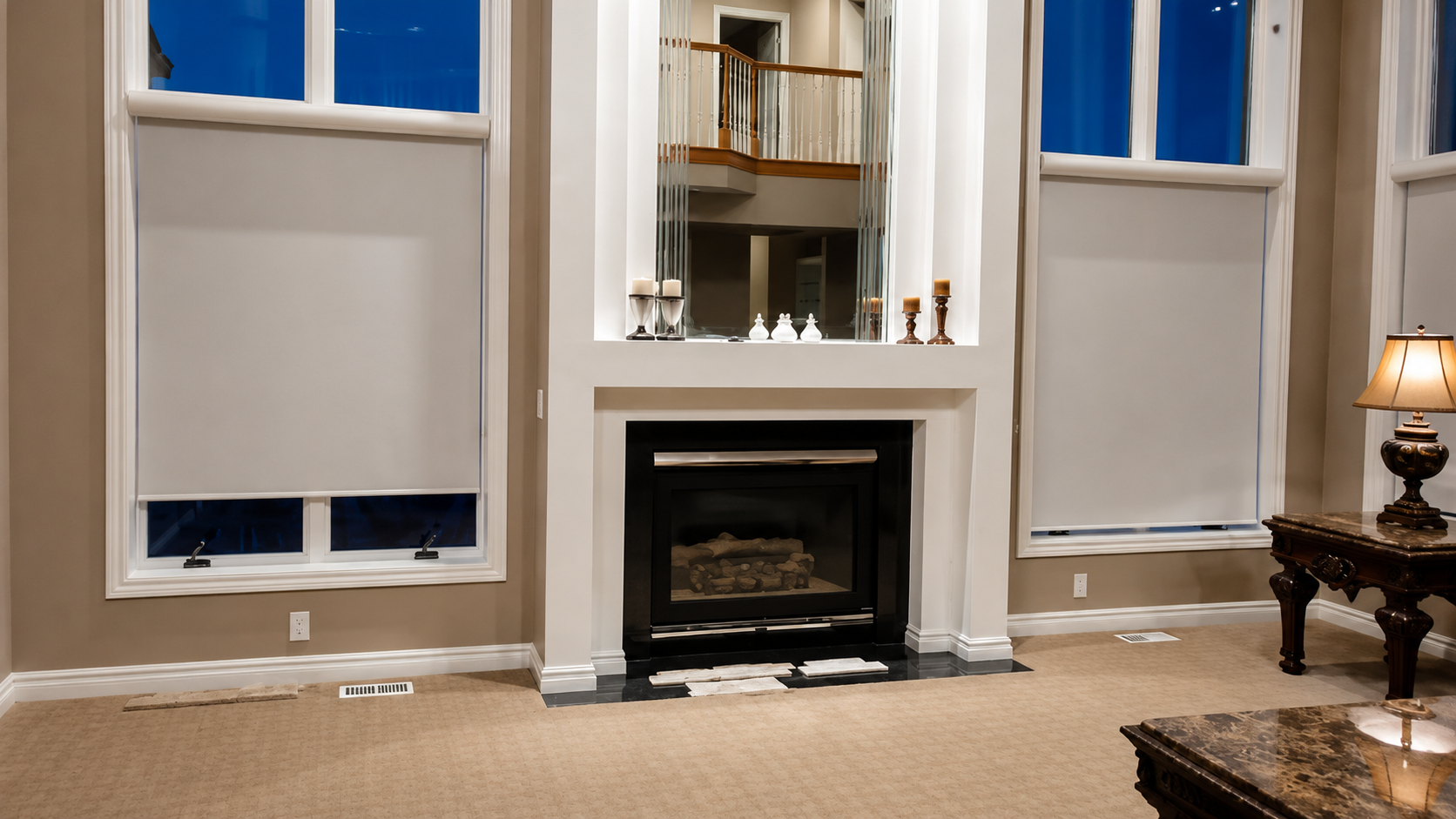 Living room with fireplace, beige walls, blue windows, and a side table lamp
