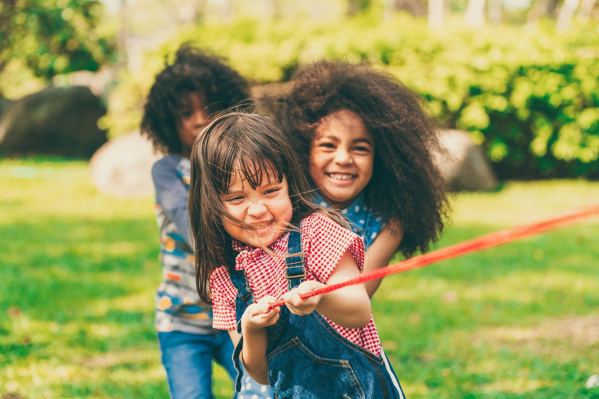 Happy Children Playing Tug of War — Baton Rouge, LA — A Lil One’s Learning Center