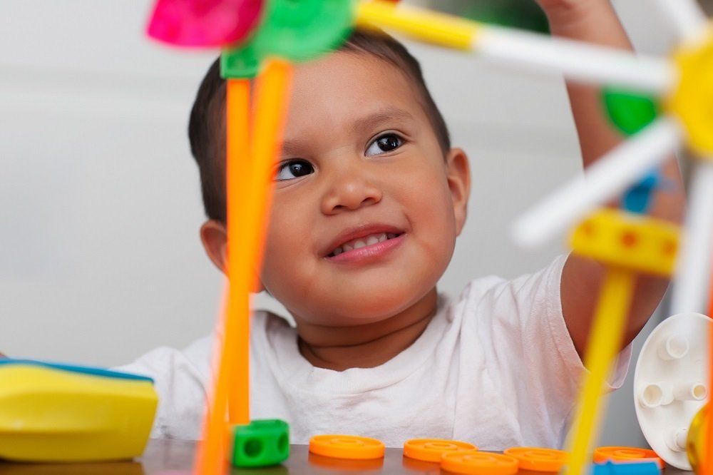 Toddler Playing with Building Blocks — Baton Rouge, LA — A Lil One’s Learning Center