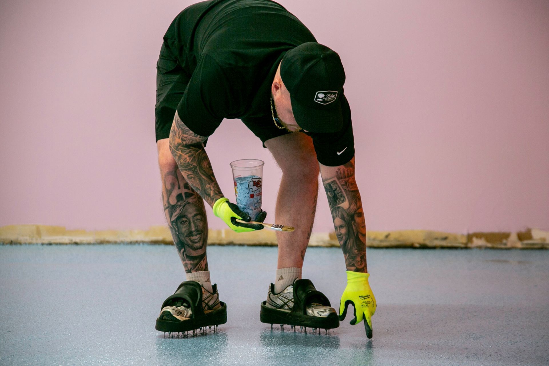 Restaurant interior with tables and chairs, large windows, and artwork.