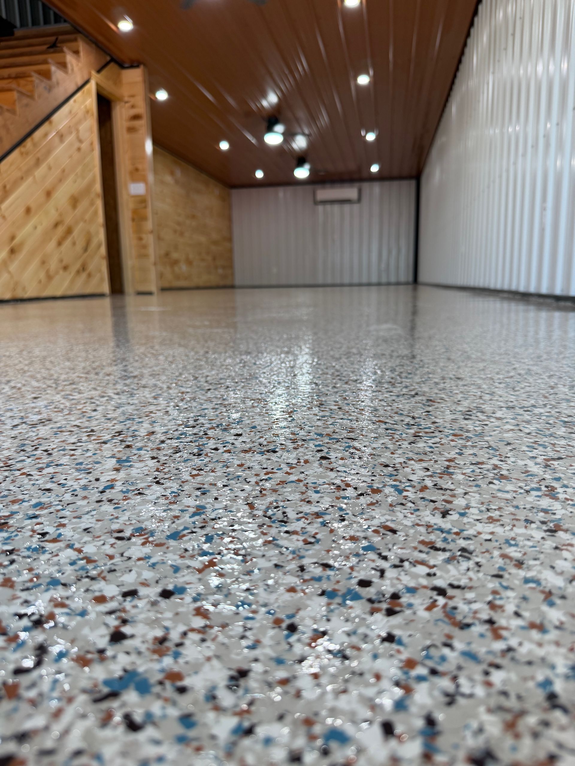 Modern dining room with a table, chairs, fireplace, and white and marble flooring.