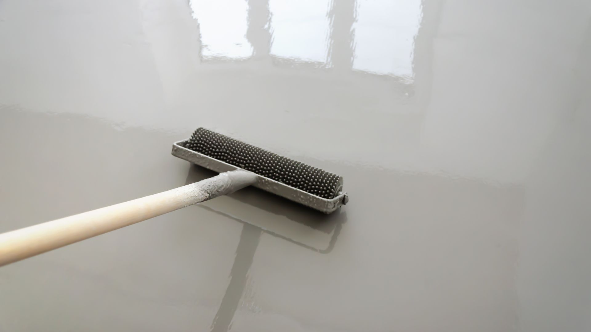 Interior of a restaurant with blue chairs, tables, and large windows with outdoor views.