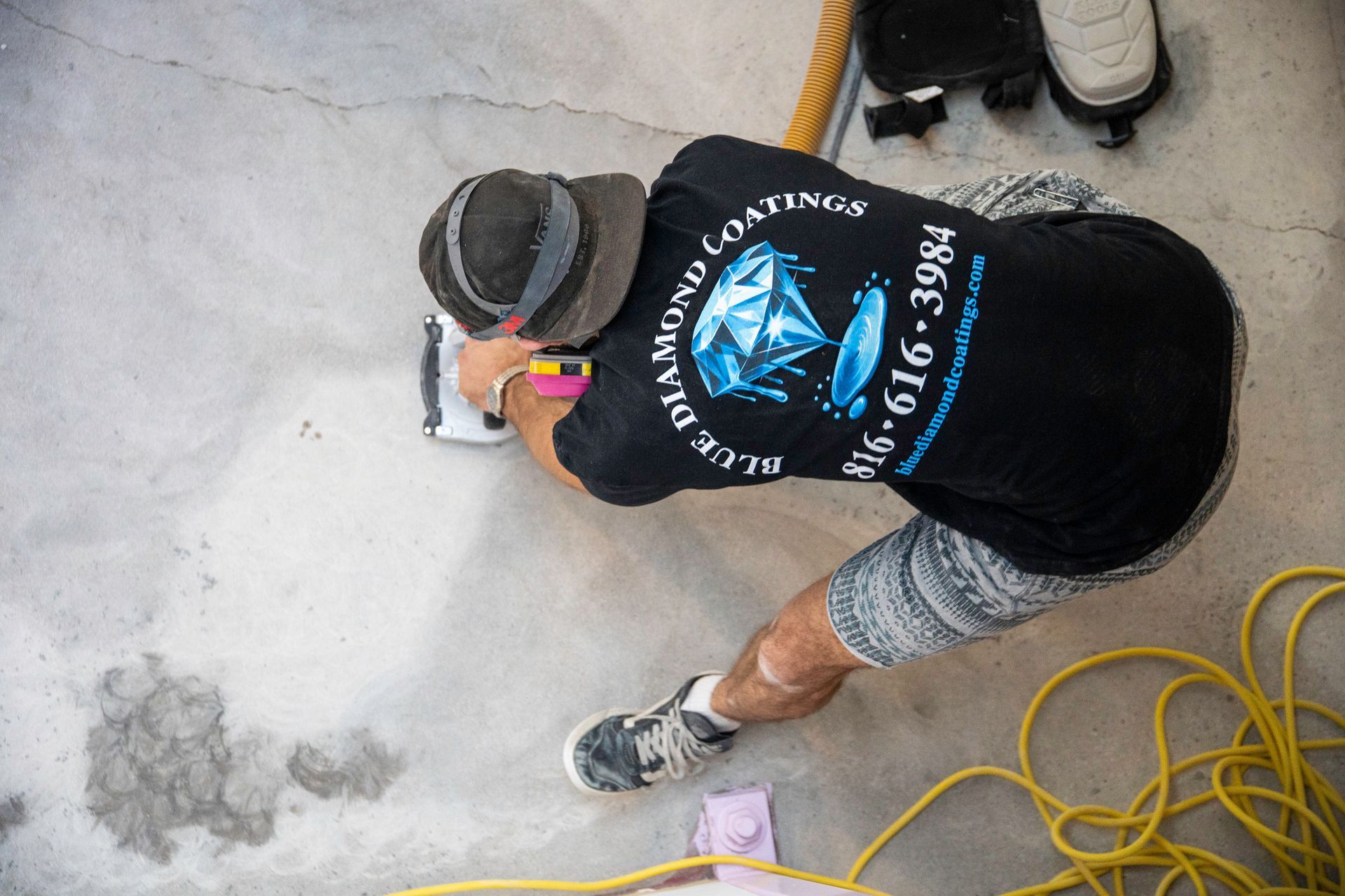Spacious restaurant interior with tables, chairs, and decorative lighting. Pink and gray color scheme.