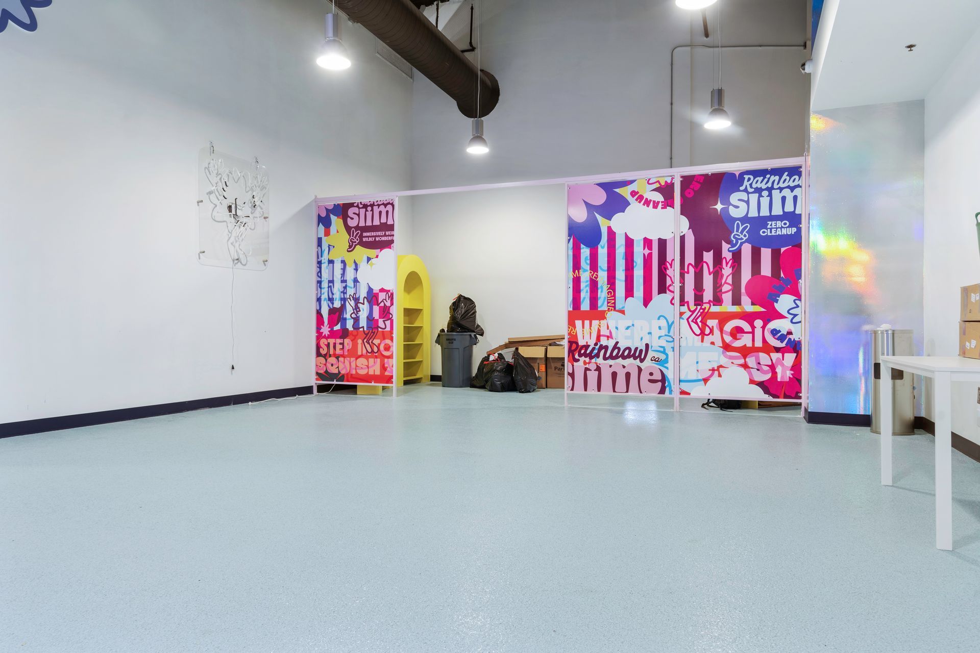 Warehouse interior with rows of shelving filled with stacked boxes and pallets.
