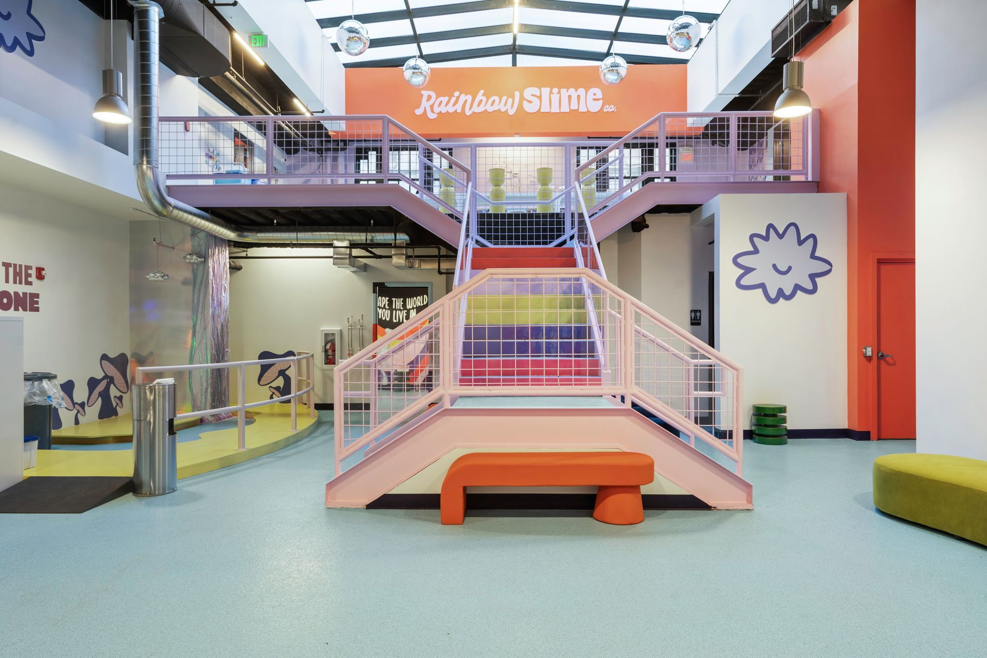 Orange epoxy floor reflecting white walls and doorways in a brightly lit room.