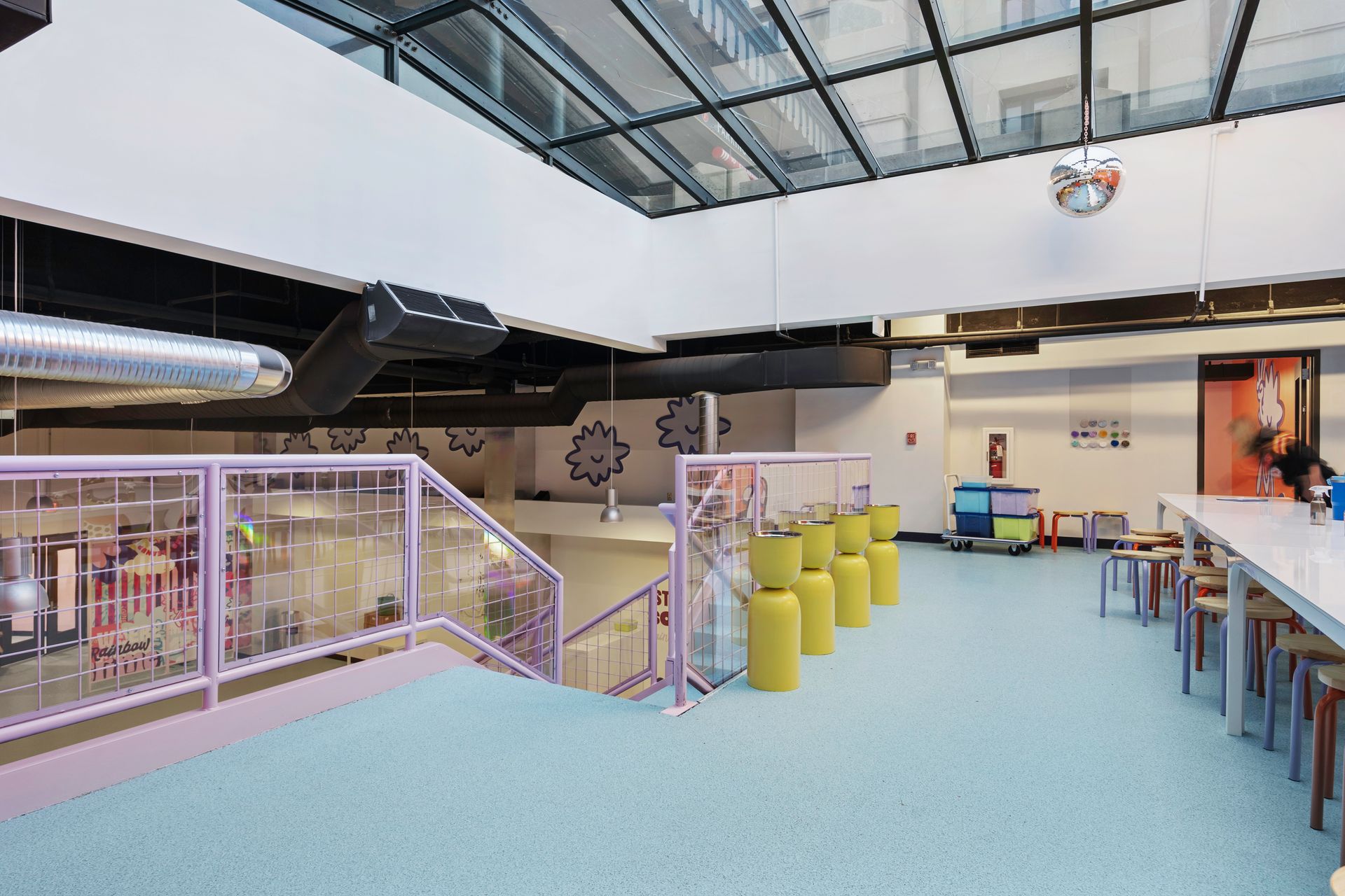 Rows of packaged machinery on pallets in a large warehouse with a high ceiling.