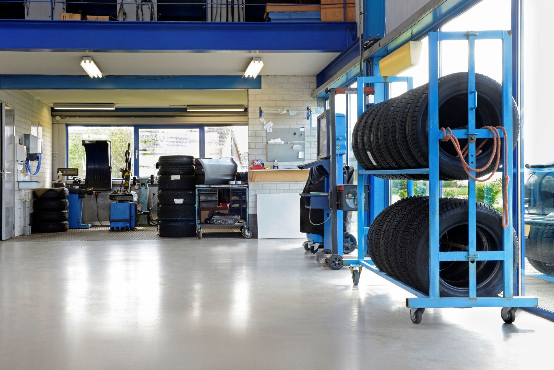 Inside of a cluttered industrial workshop with tools, machinery, and workbenches.
