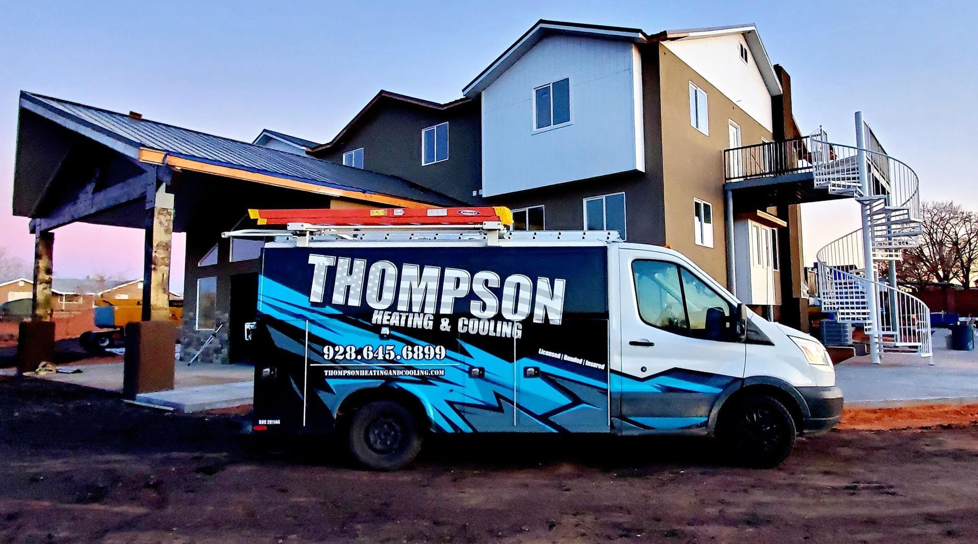 Thompson heating and cooling van outside a home