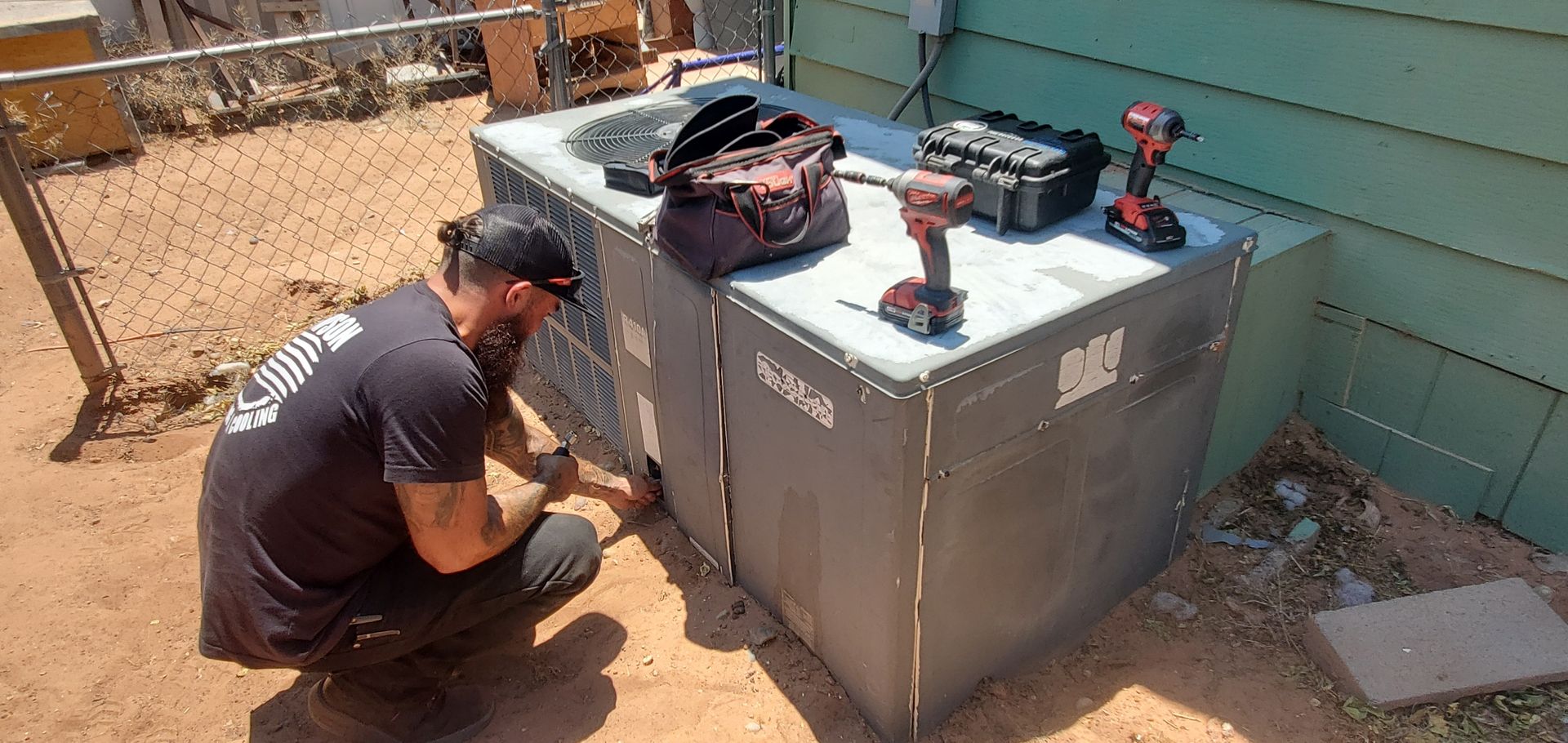 Thompson_AC_technician_working_maintaining_unit_page AZ