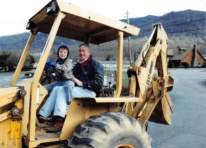 Fox Run Apartments owners with backhoe in Maggie Valley, NC