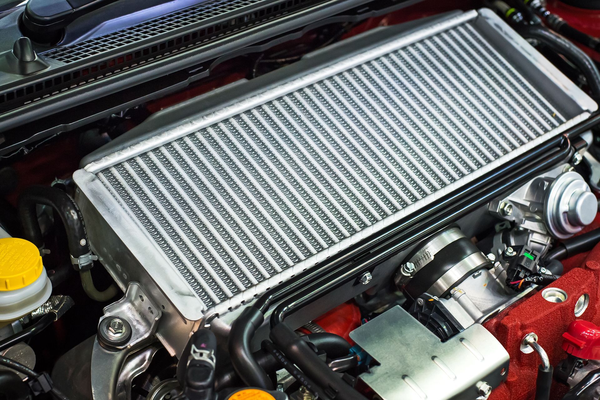 A close up of a car engine with a radiator.