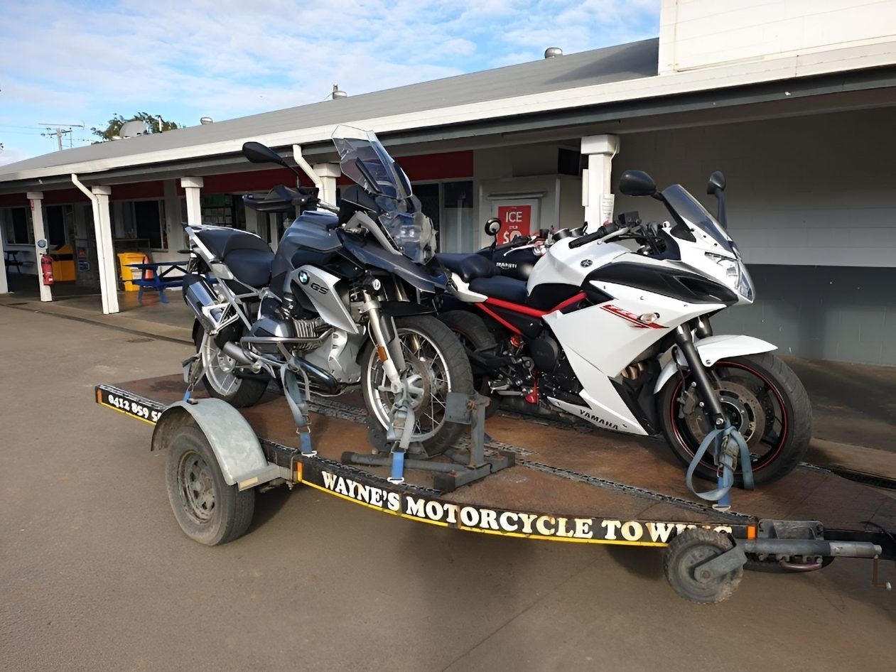 Two Motorcycles Are Being Towed On A Trailer — Motorcycle Transporters In Manunda, QLD