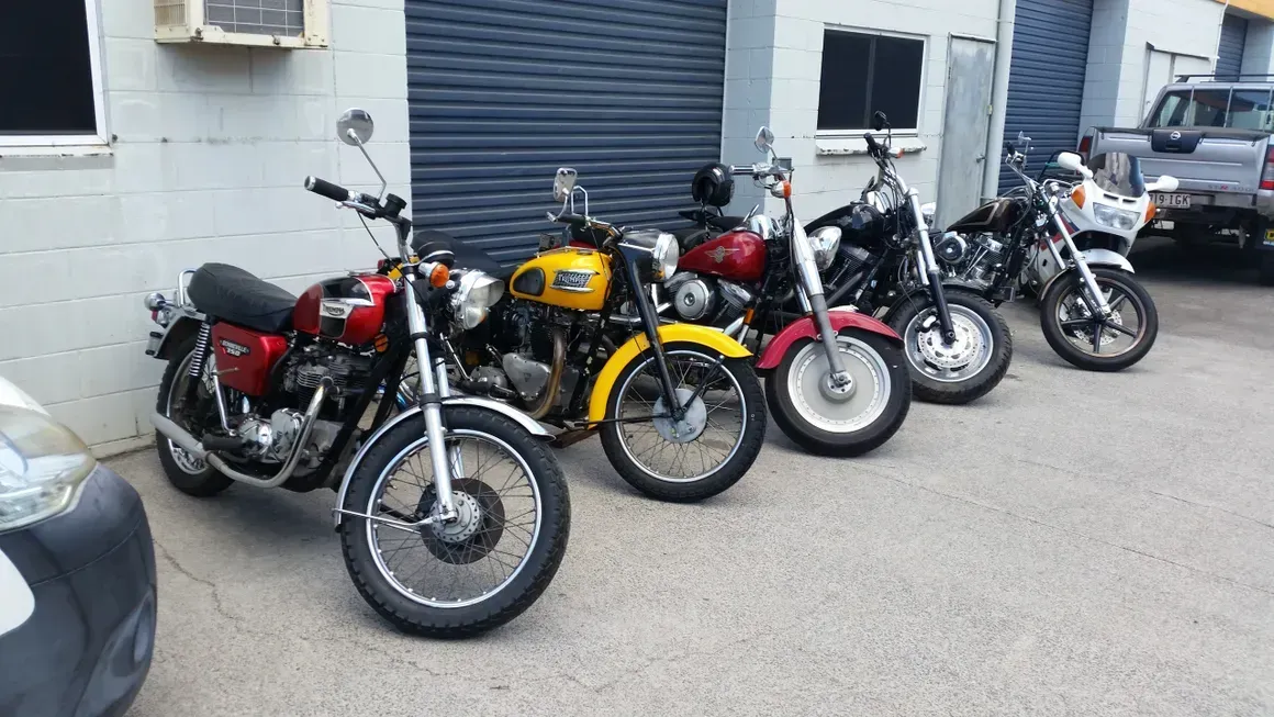 A Row Of Motorcycles Parked In Front Of A Building — Motorcycle Transporters In Manunda, QLD