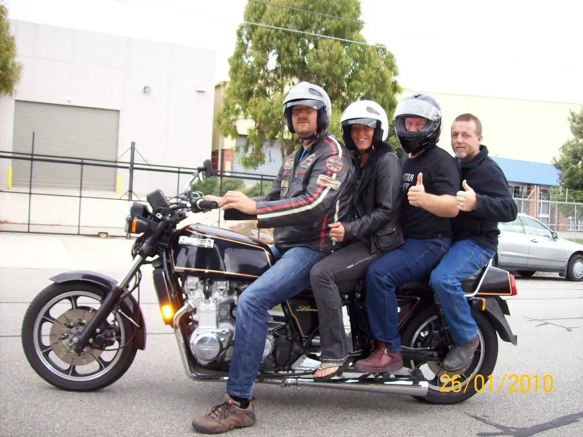 A Group Of People Sitting On A Motorcycle Giving A Thumbs Up  — Motorcycle Transporters In Manunda, QLD