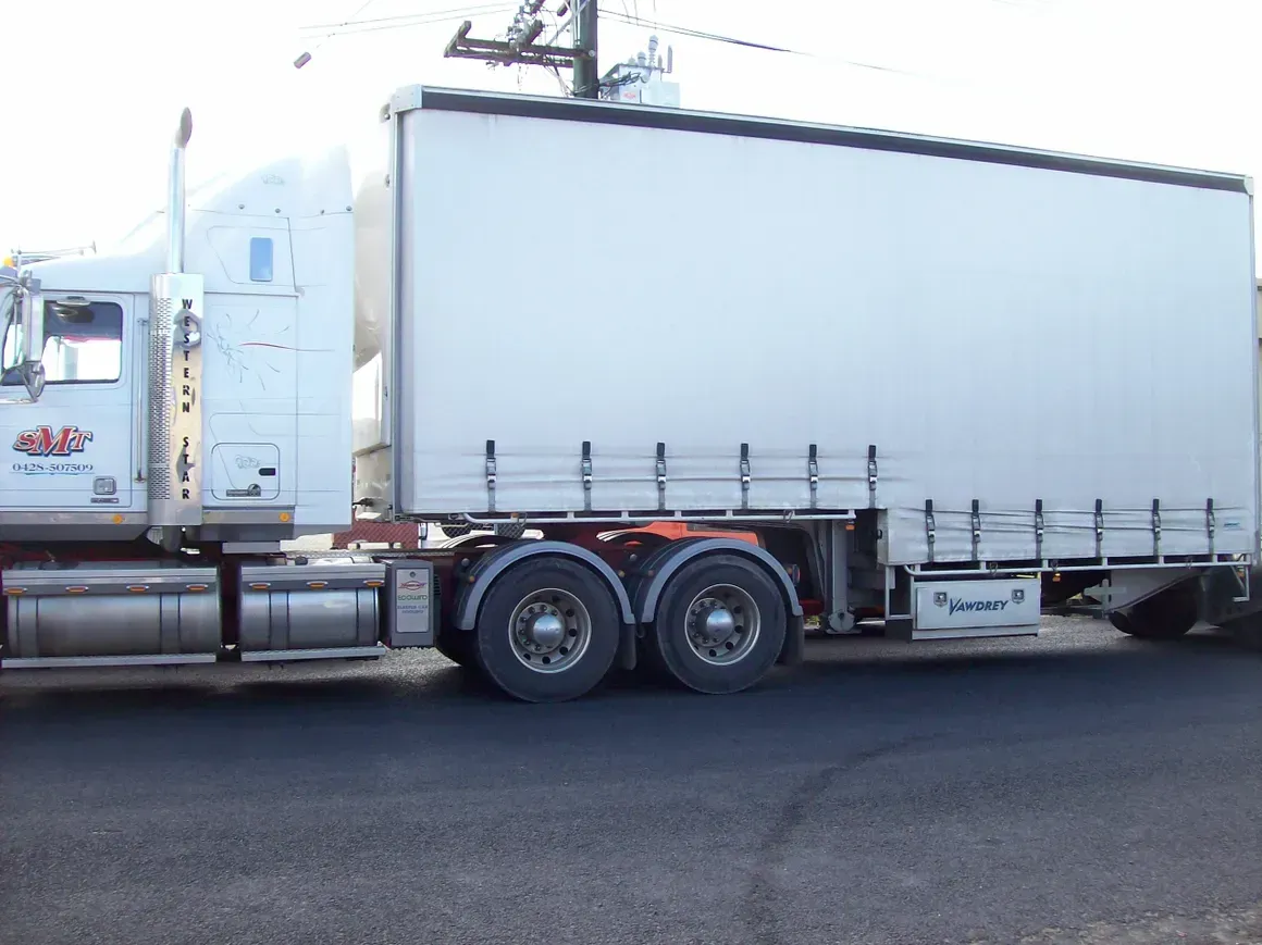 A White Truck On The Road — Motorcycle Transporters In Manunda, QLD