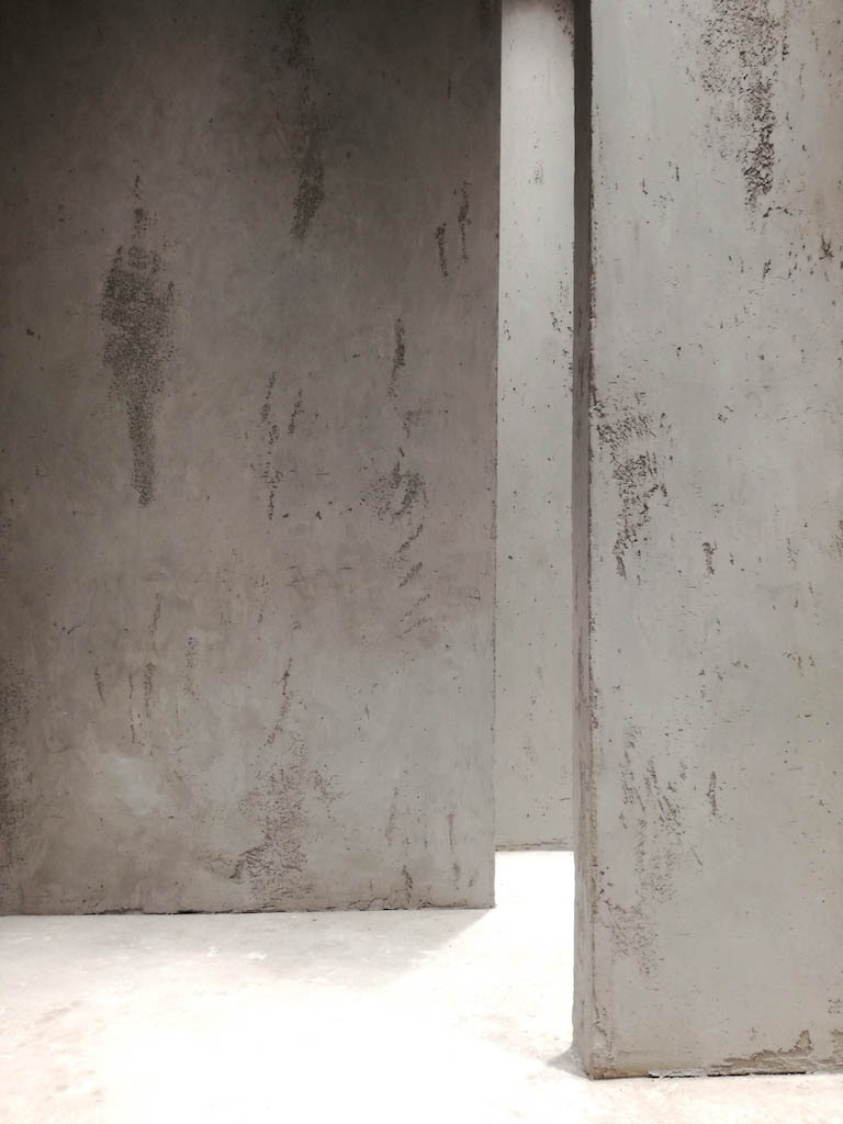 detail of a room interior with grey beton stucco plaster walls