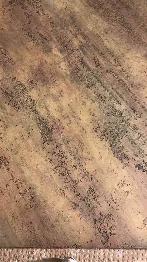 detail of a wall with orange travertino product with glazing