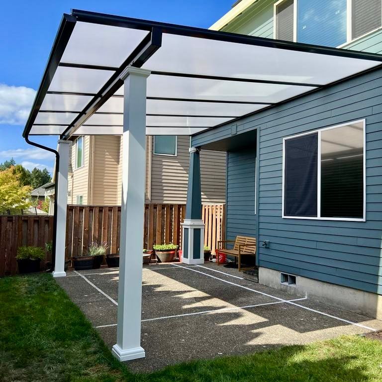 After Crown Patio Covers Installed a Black 20' x 14' Shed Style Patio Cover With Cool Blue Panels and Decorative Columns in Bethany