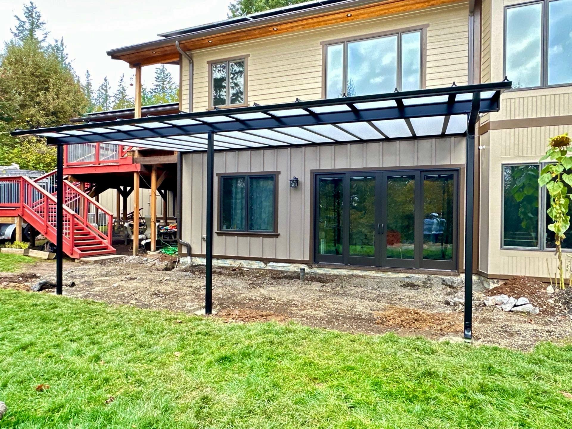 Crown Patio Covers installed a black-frame patio cover with Cool Blue panels on this home in Northwest Portland