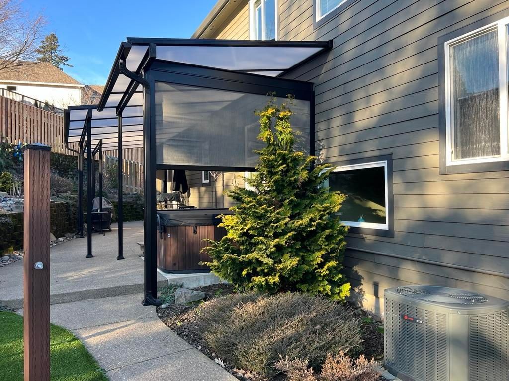 After Crown Patio Covers Installed a Large 3 shed patio covers merged into 1 - Acrylite acrylic Cool Blue Heat Stop, Black Aluminum Frame - Tigard Oregon