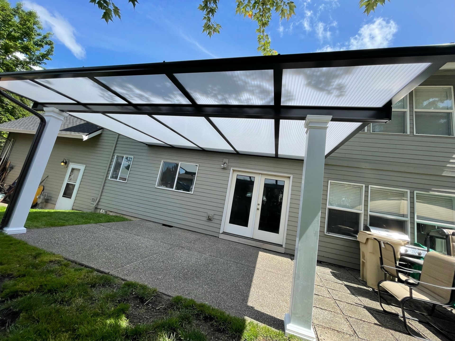 After Crown Patio Covers Installed a Brown Shed Style Patio Cover with White Pillars on this house in Wilsonville Oregon