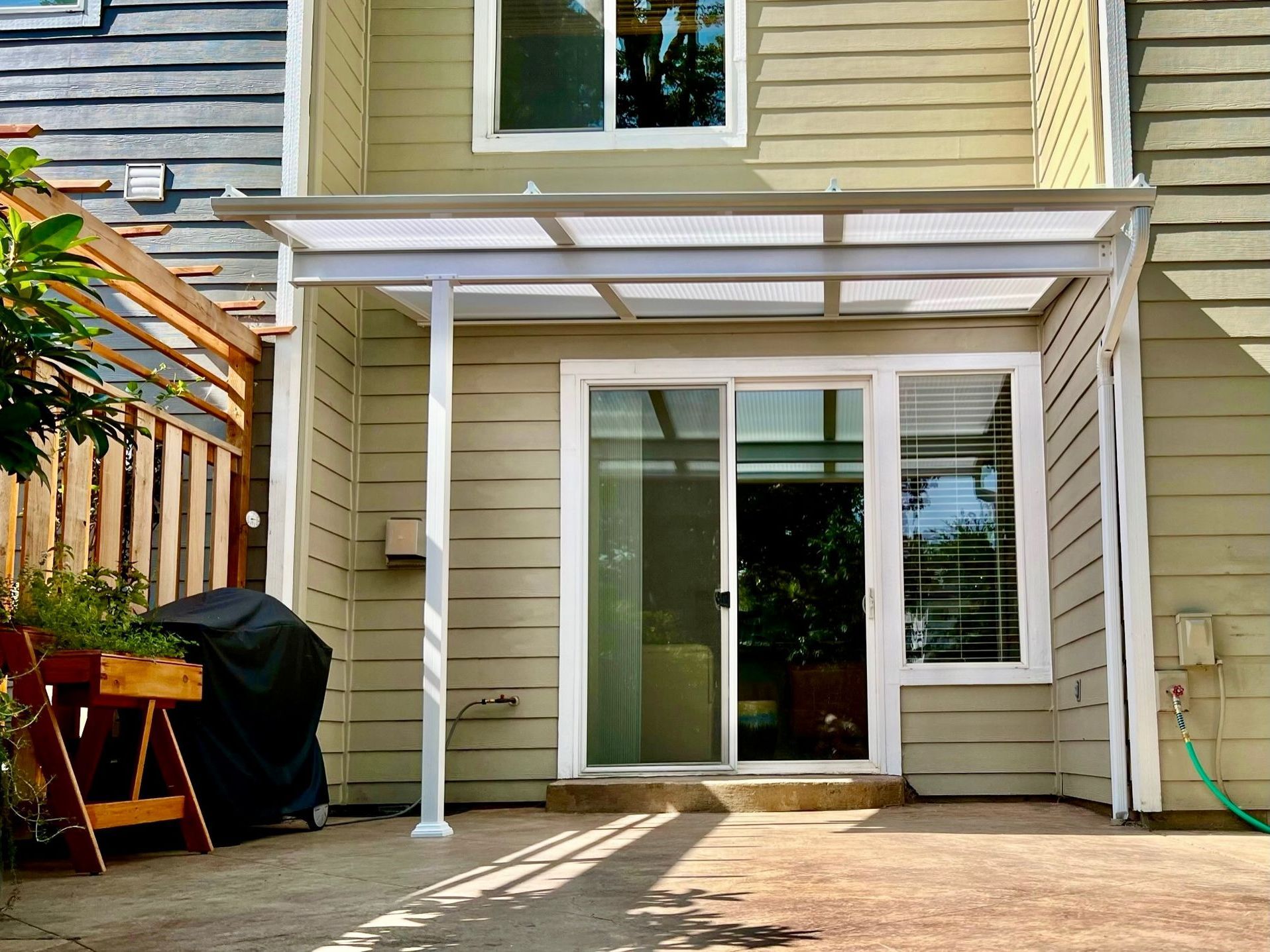 After Crown Patio Covers Installed a White Shed Style Patio Cover on this house in West Linn