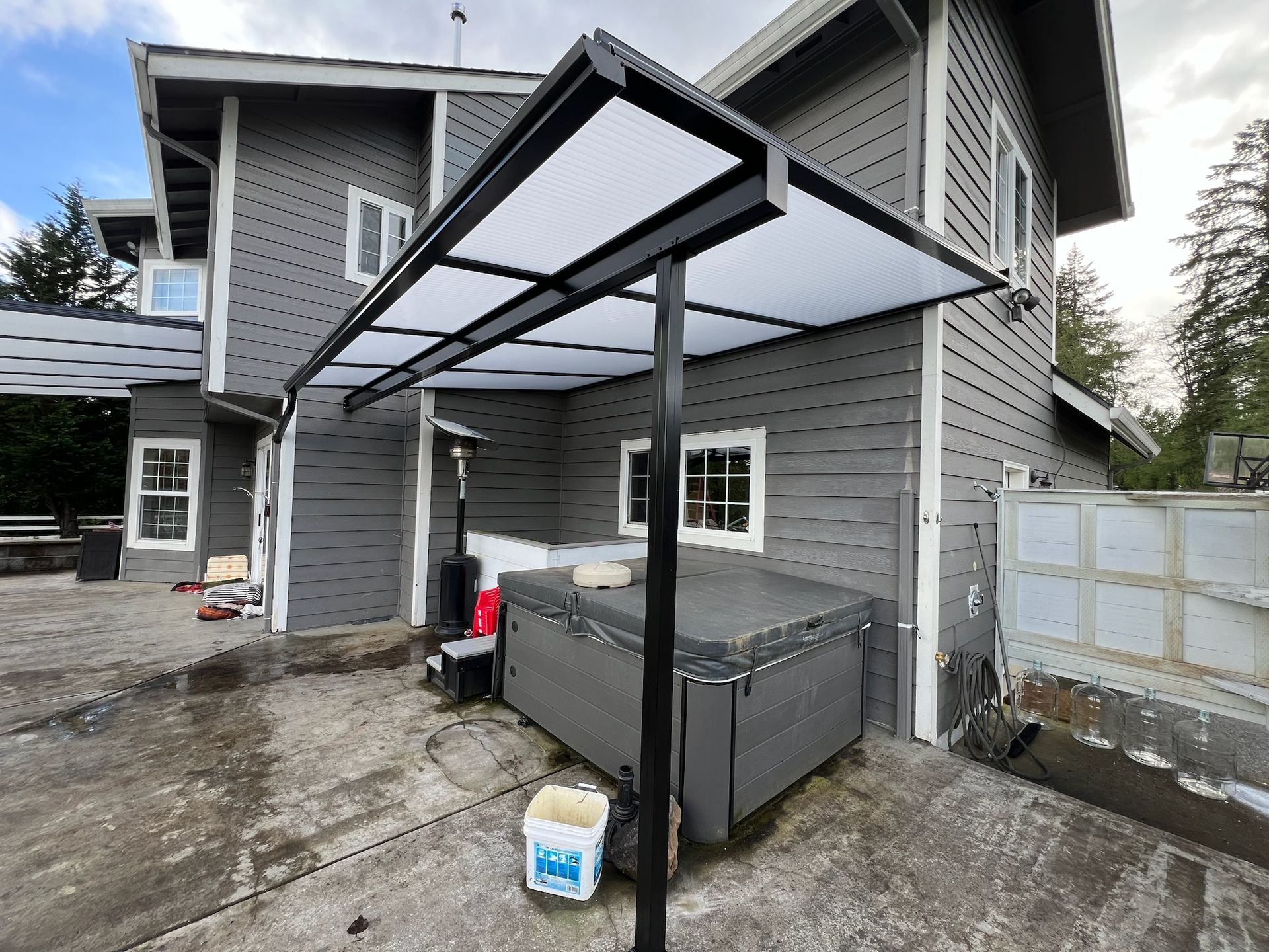Battle Ground WA Patio Cover Project by Crown Patio Covers - Black Shed frame with White Acryite acrylic top