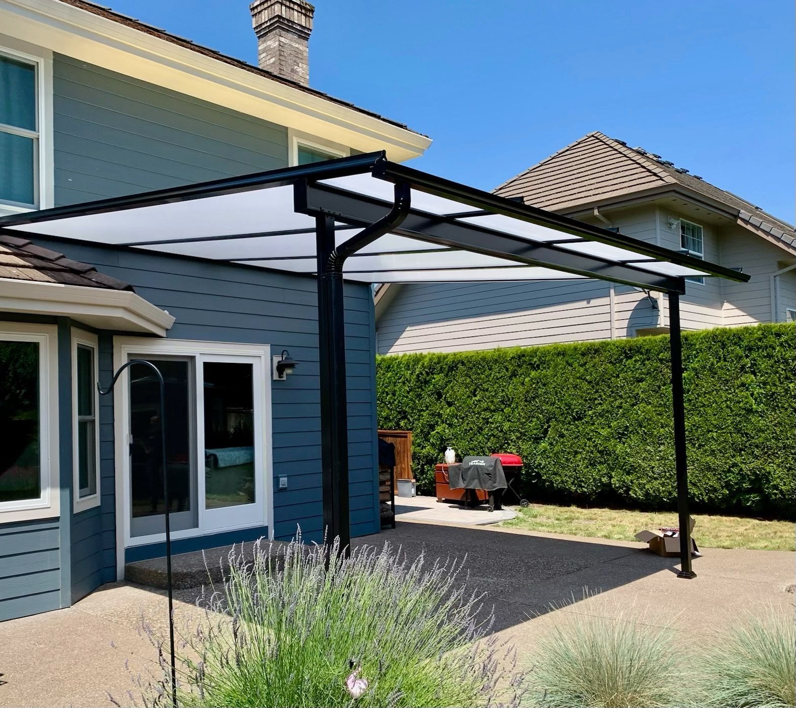 Hazel Dell WA Patio Cover Project - Shed style frame in black with white Acrylite acrylic top by Crown Patio Covers LLC