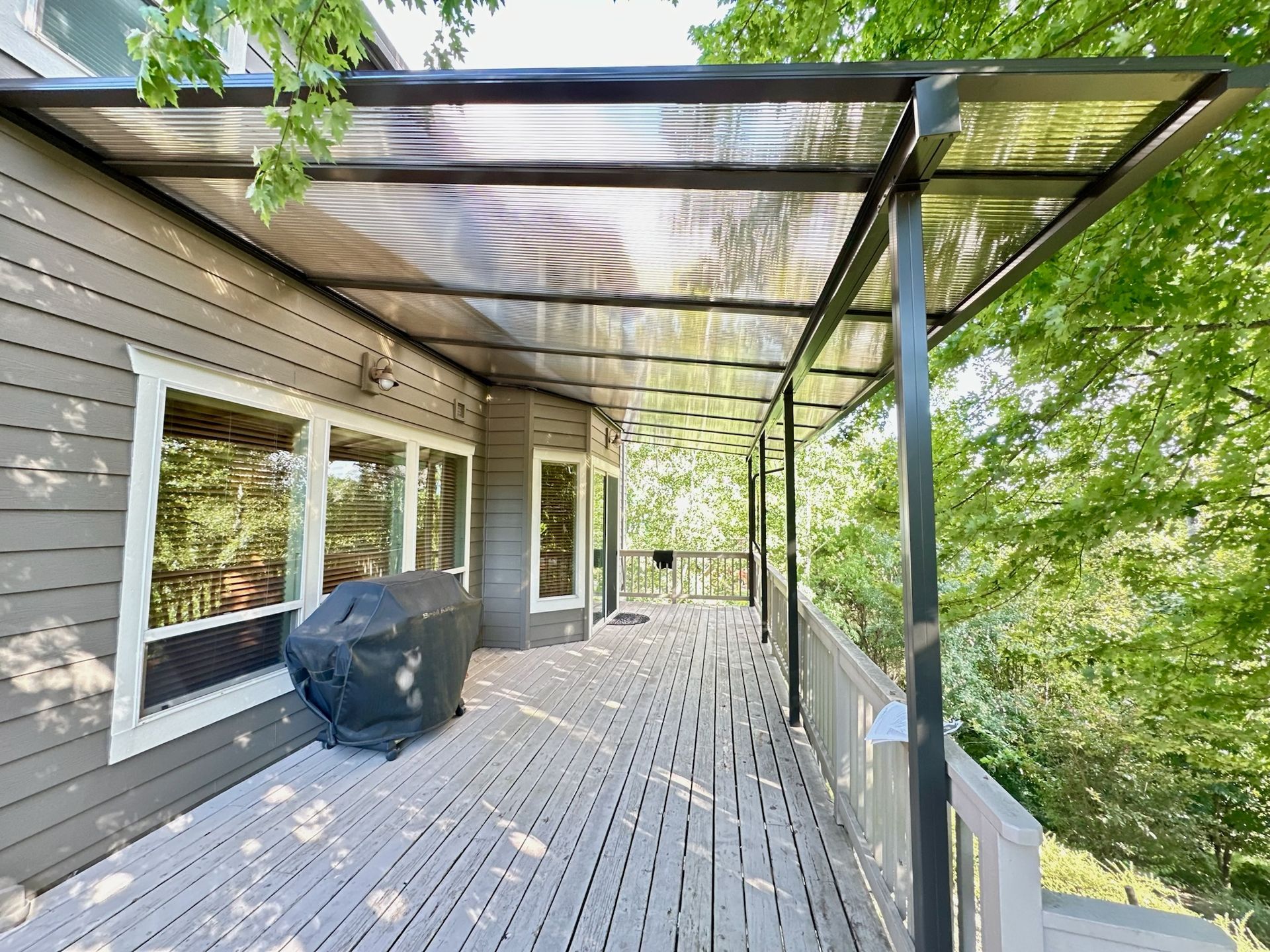 South Salem Oregon Patio Cover Project - Shed style frame in black with Acrylite acrylic heatstop cover built by Crown Patio Covers