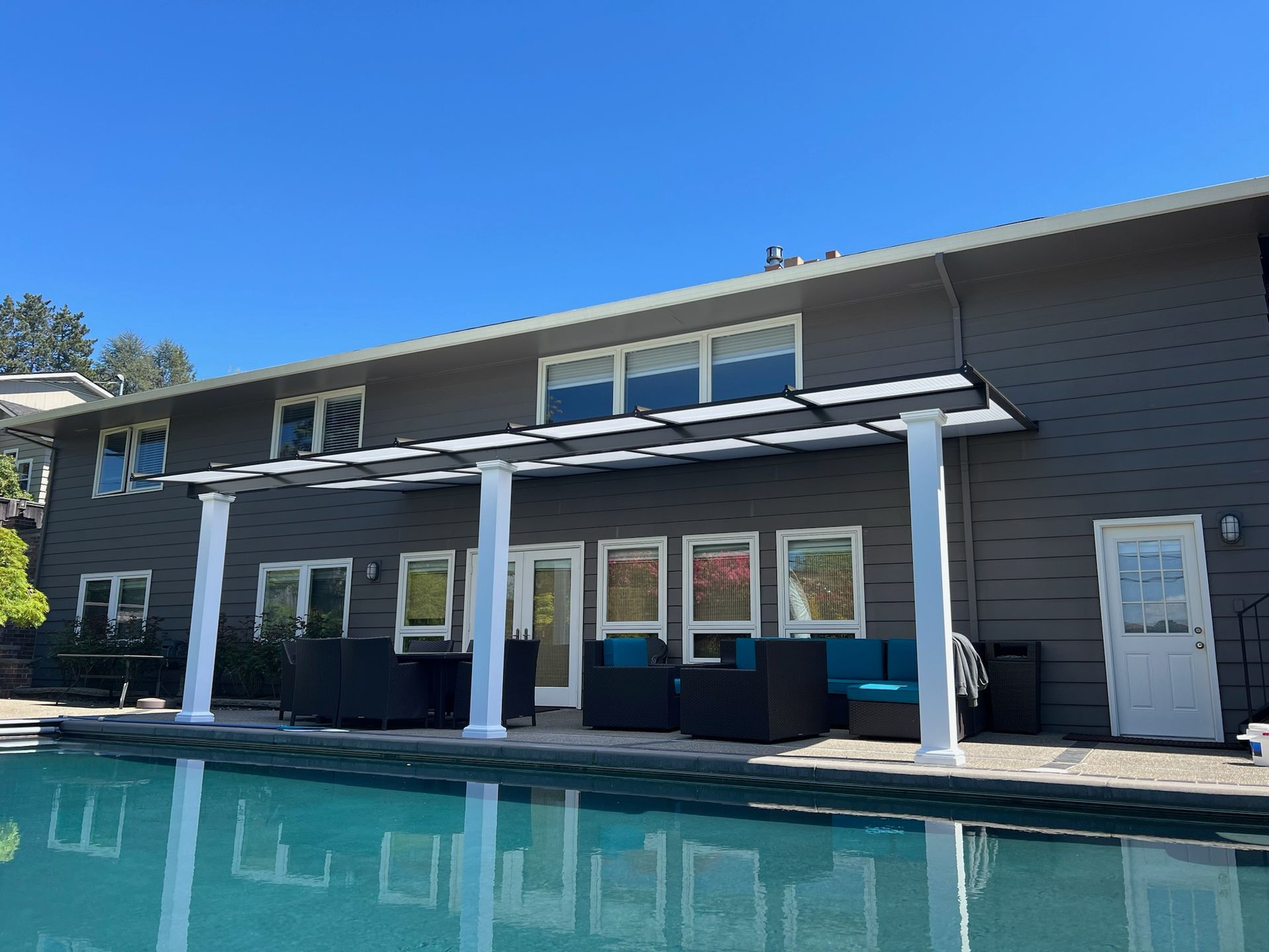 West Portland Patio Cover Build - Shed style cover with white posts and black top with Acrylite acrylic Heat Stop cover built by Crown Patio Covers LLC