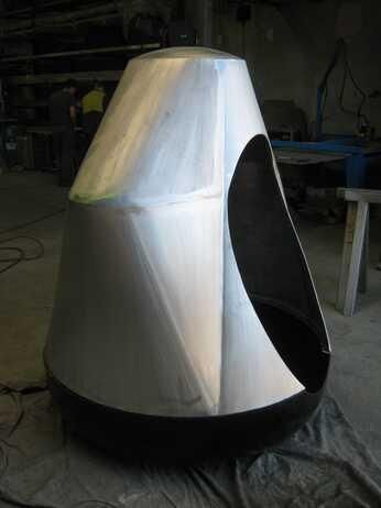 A large metal object is sitting on the floor in a room.