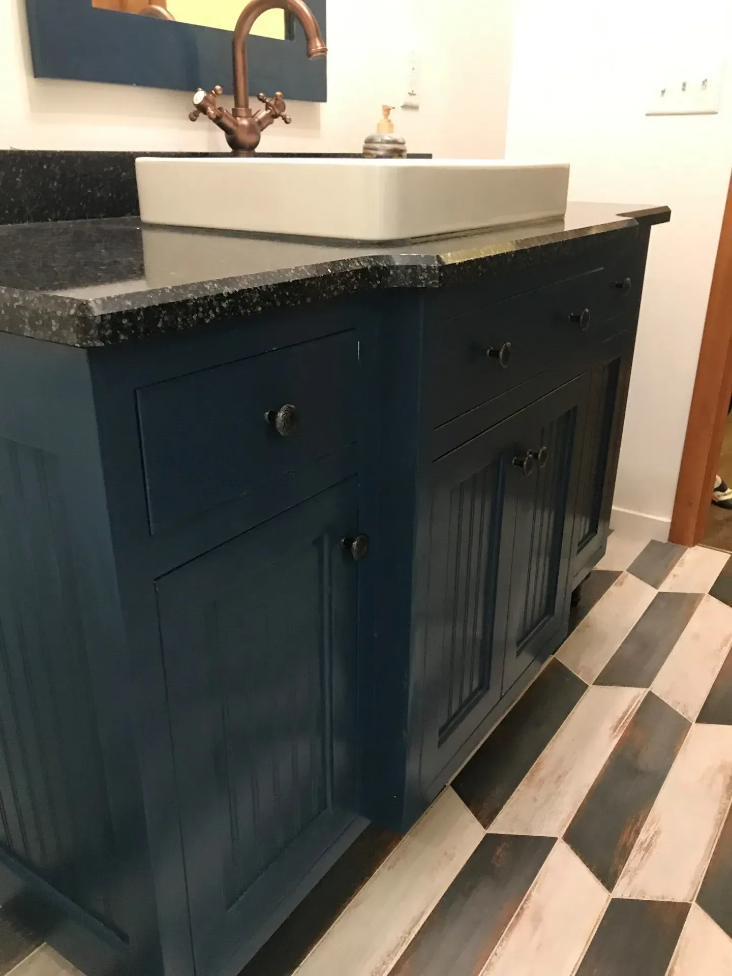 A bathroom vanity with a sink and a mirror