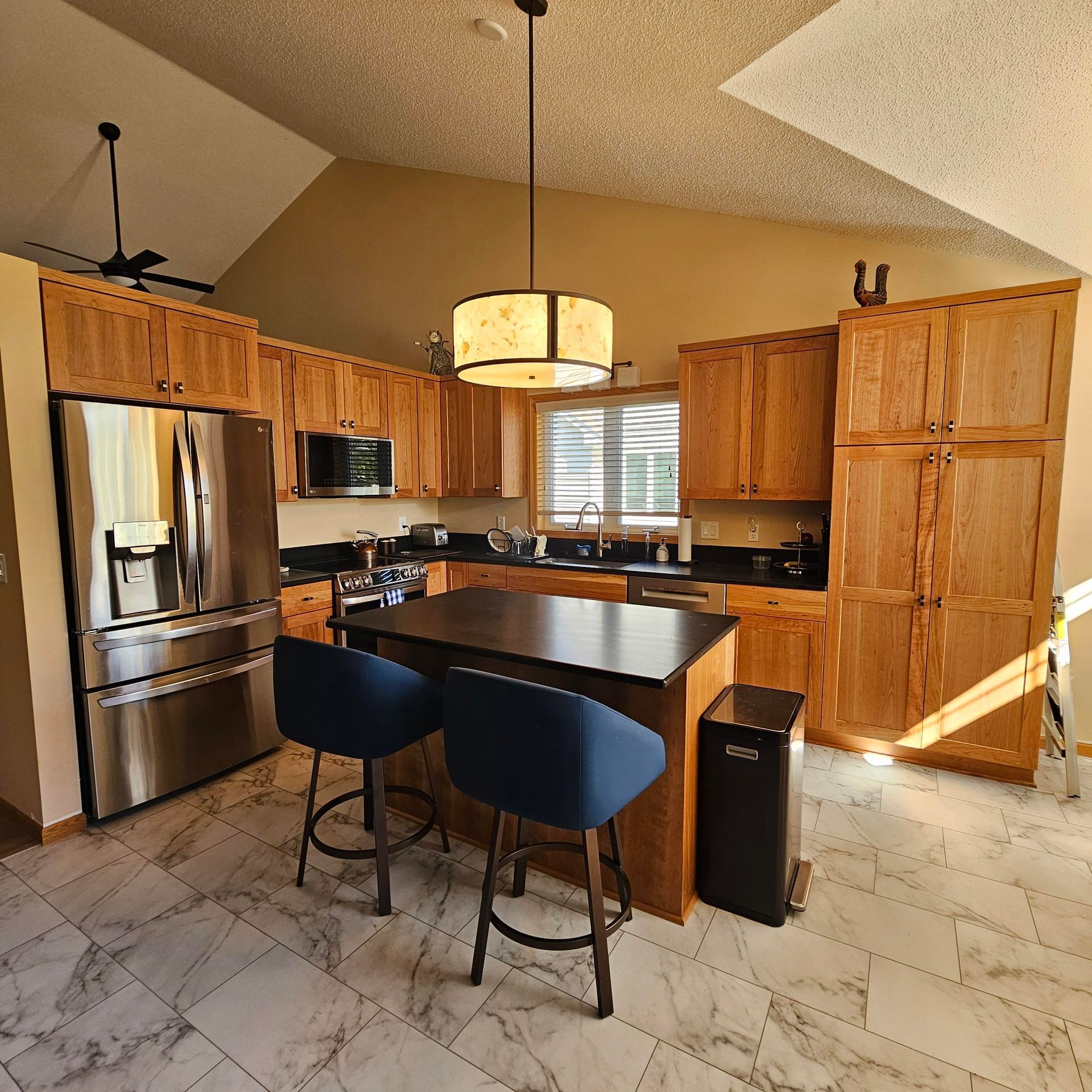 A kitchen with stainless steel appliances and wooden cabinets