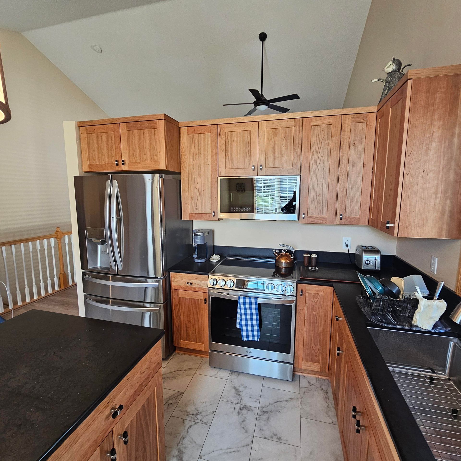 A kitchen with stainless steel appliances and wooden cabinets