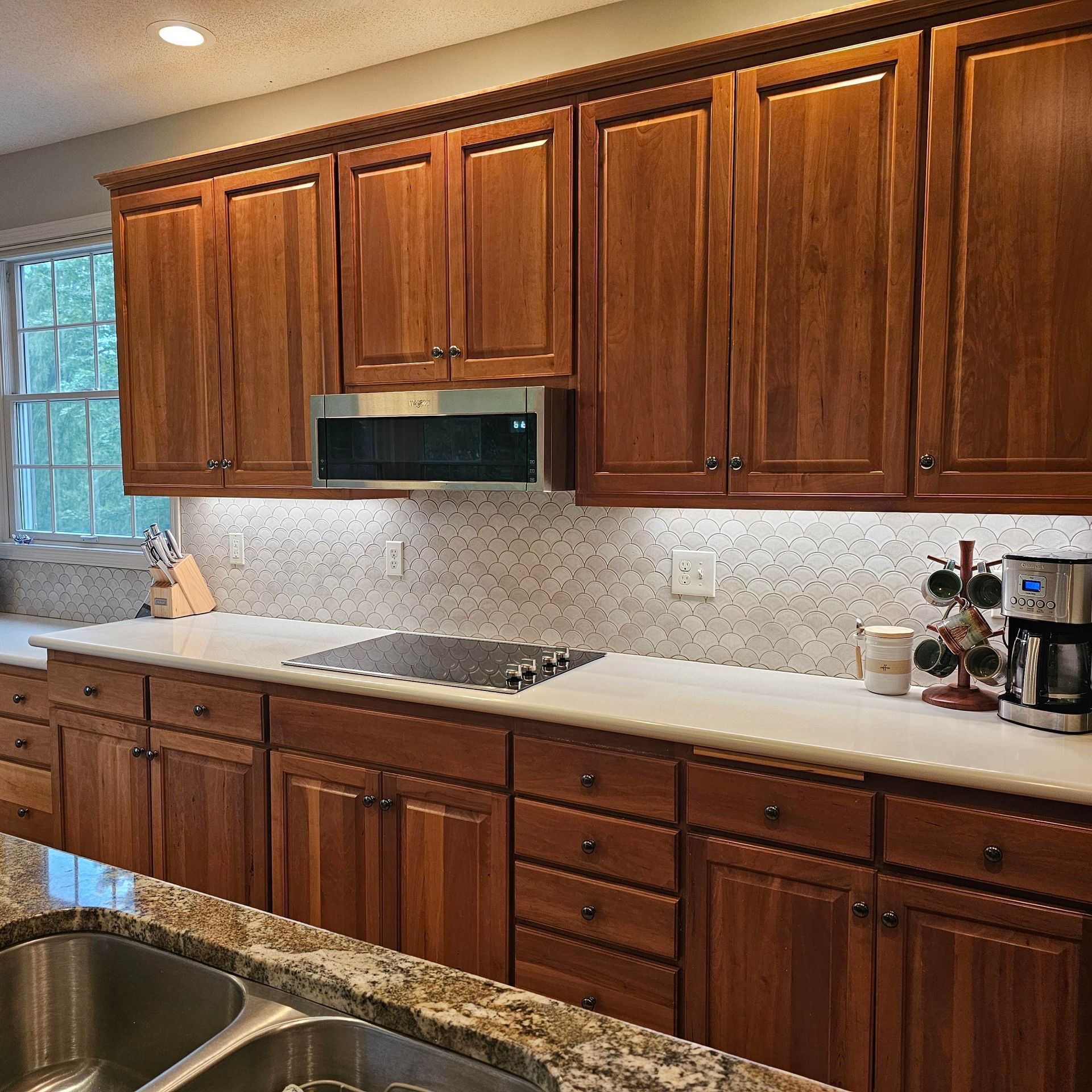 A kitchen with wooden cabinets and granite counter tops