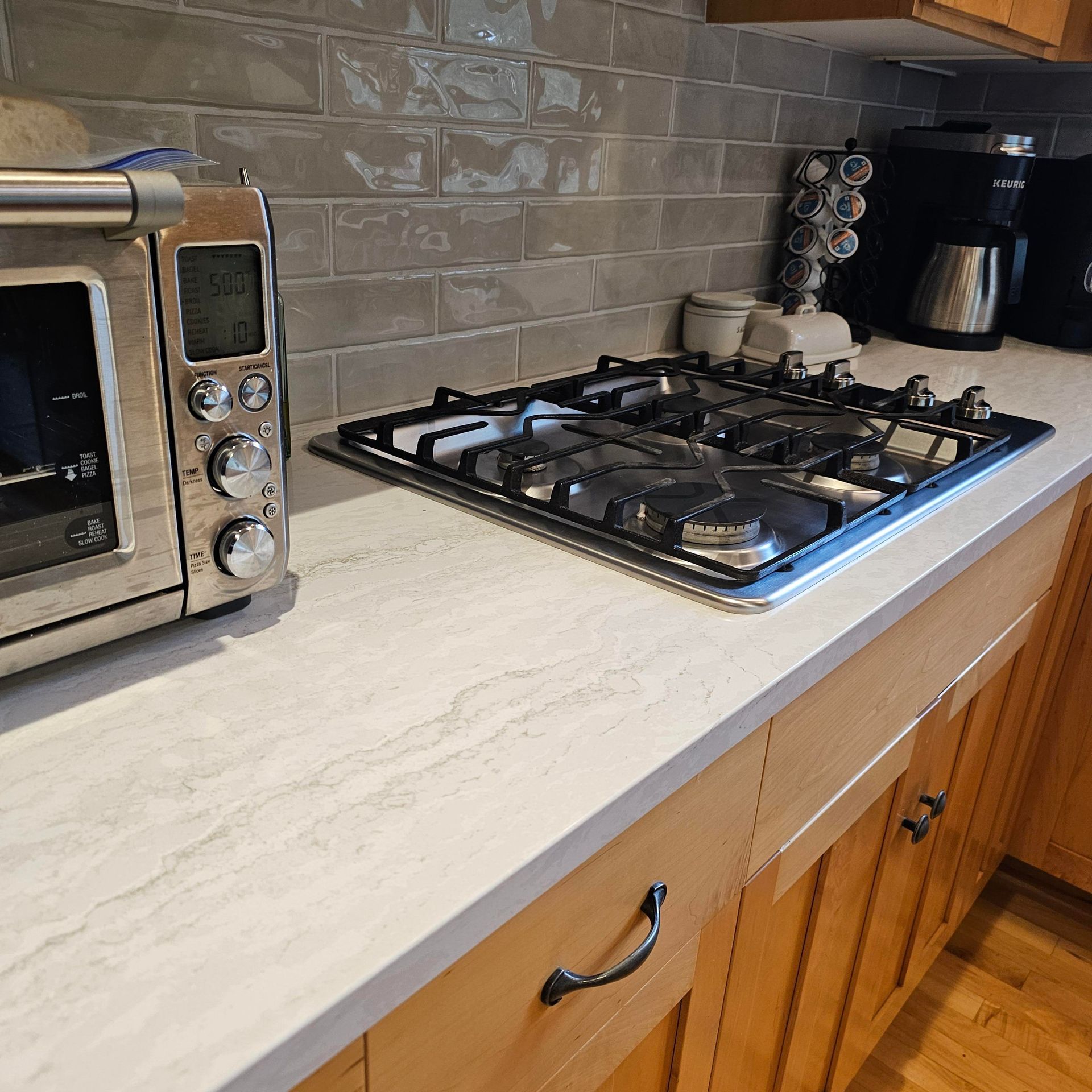 A kitchen with a stove top oven and a microwave
