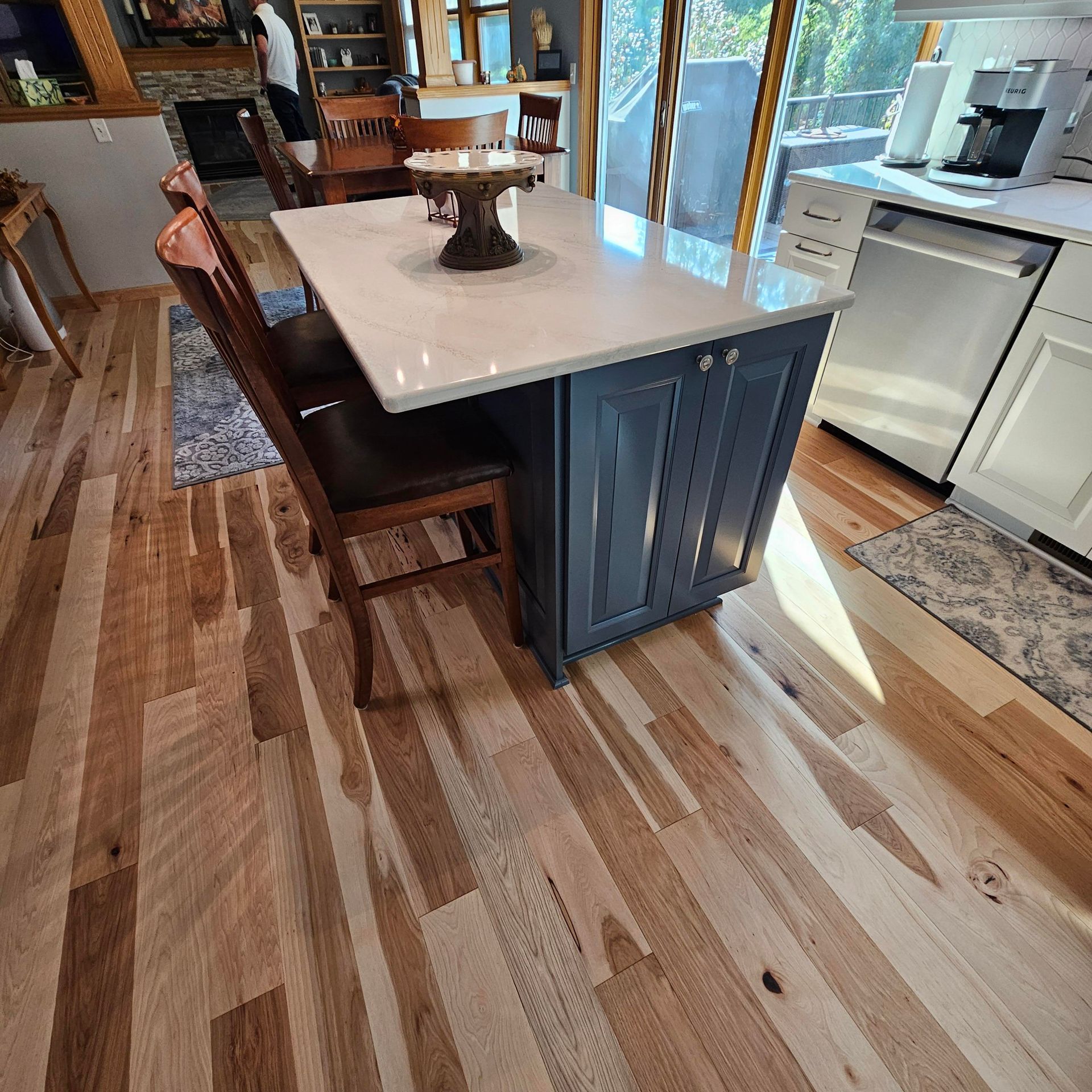A kitchen with wooden floors and a table and chairs