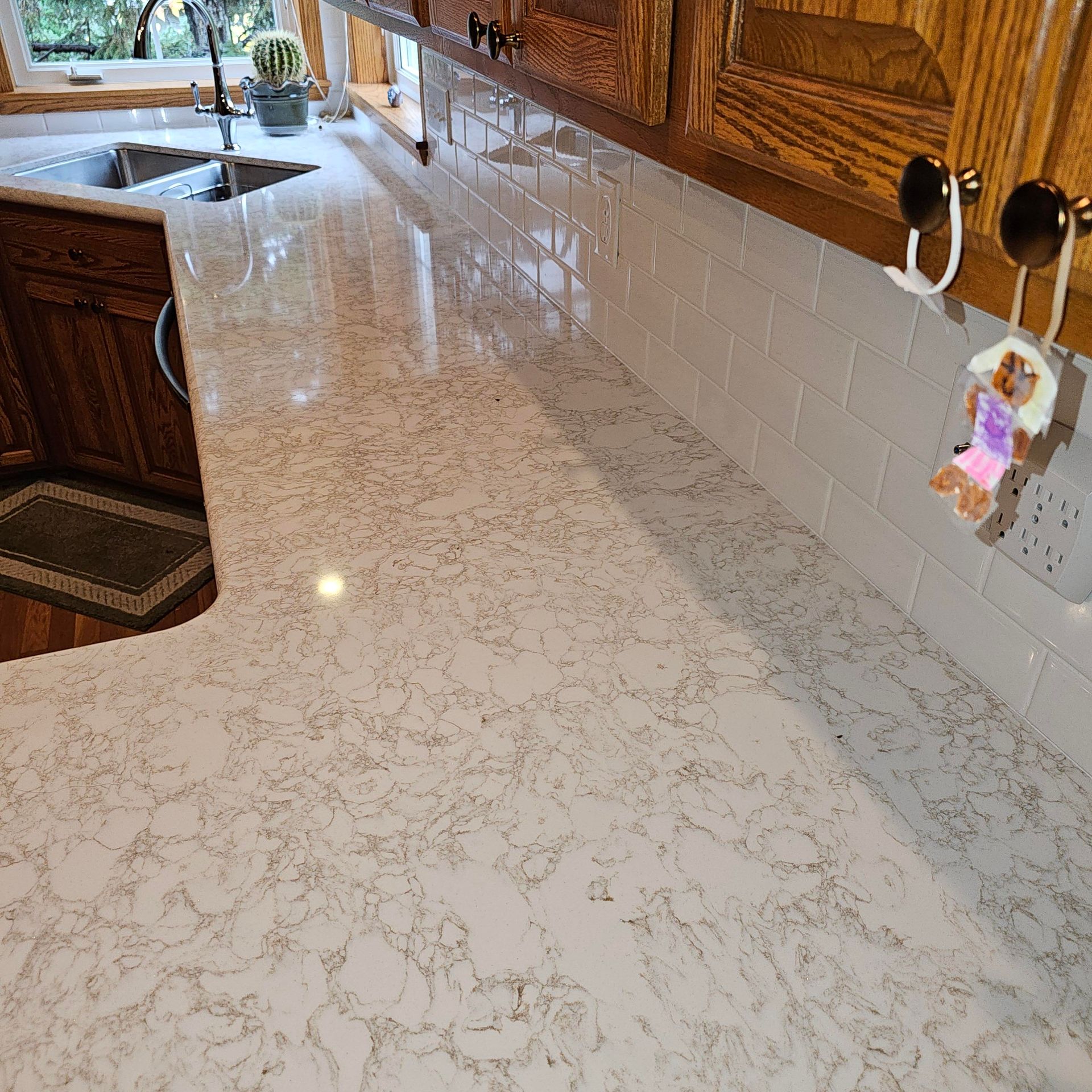 A kitchen with a white counter top and wooden cabinets