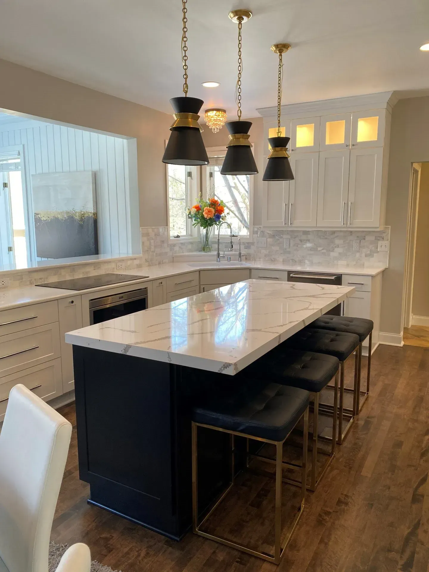 A kitchen with a large island and stools