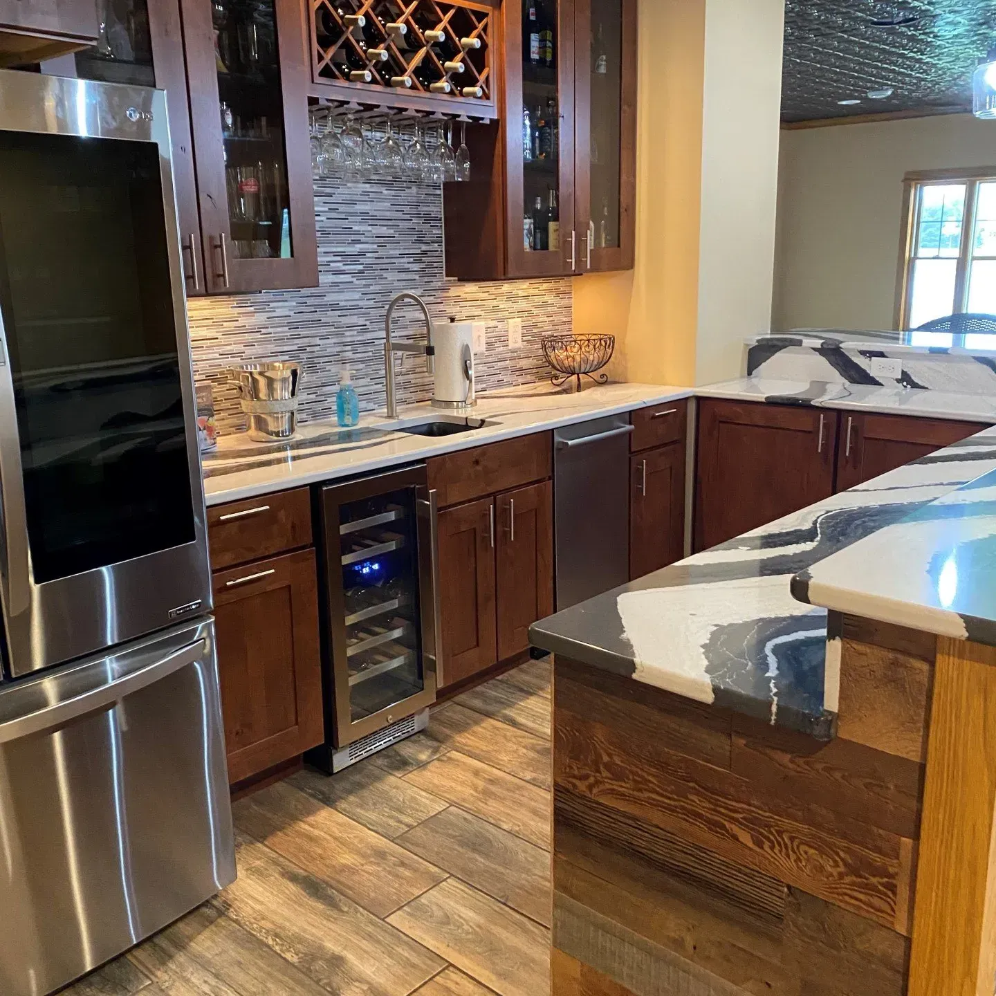A kitchen with stainless steel appliances and wooden cabinets