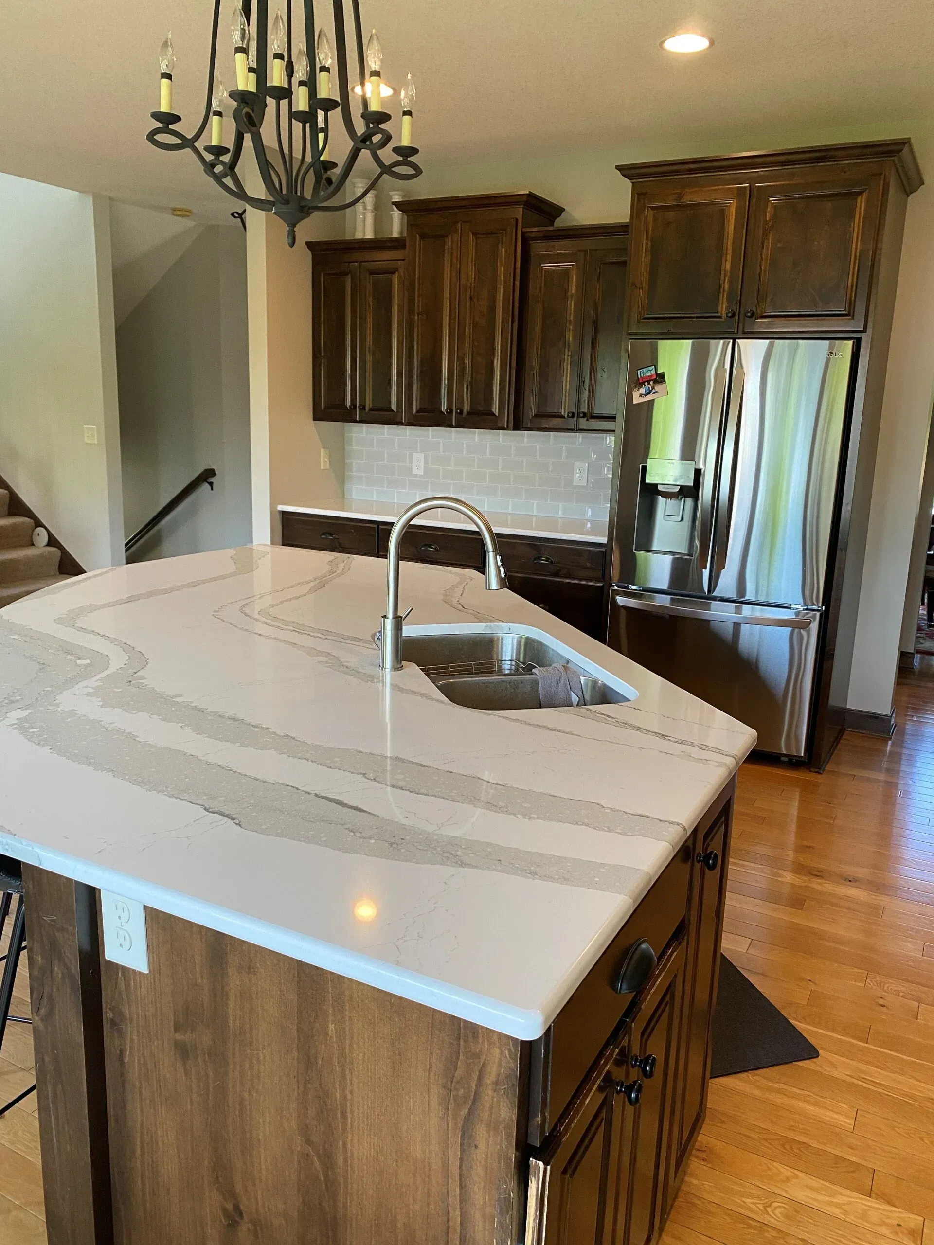 A kitchen with a large island and a sink