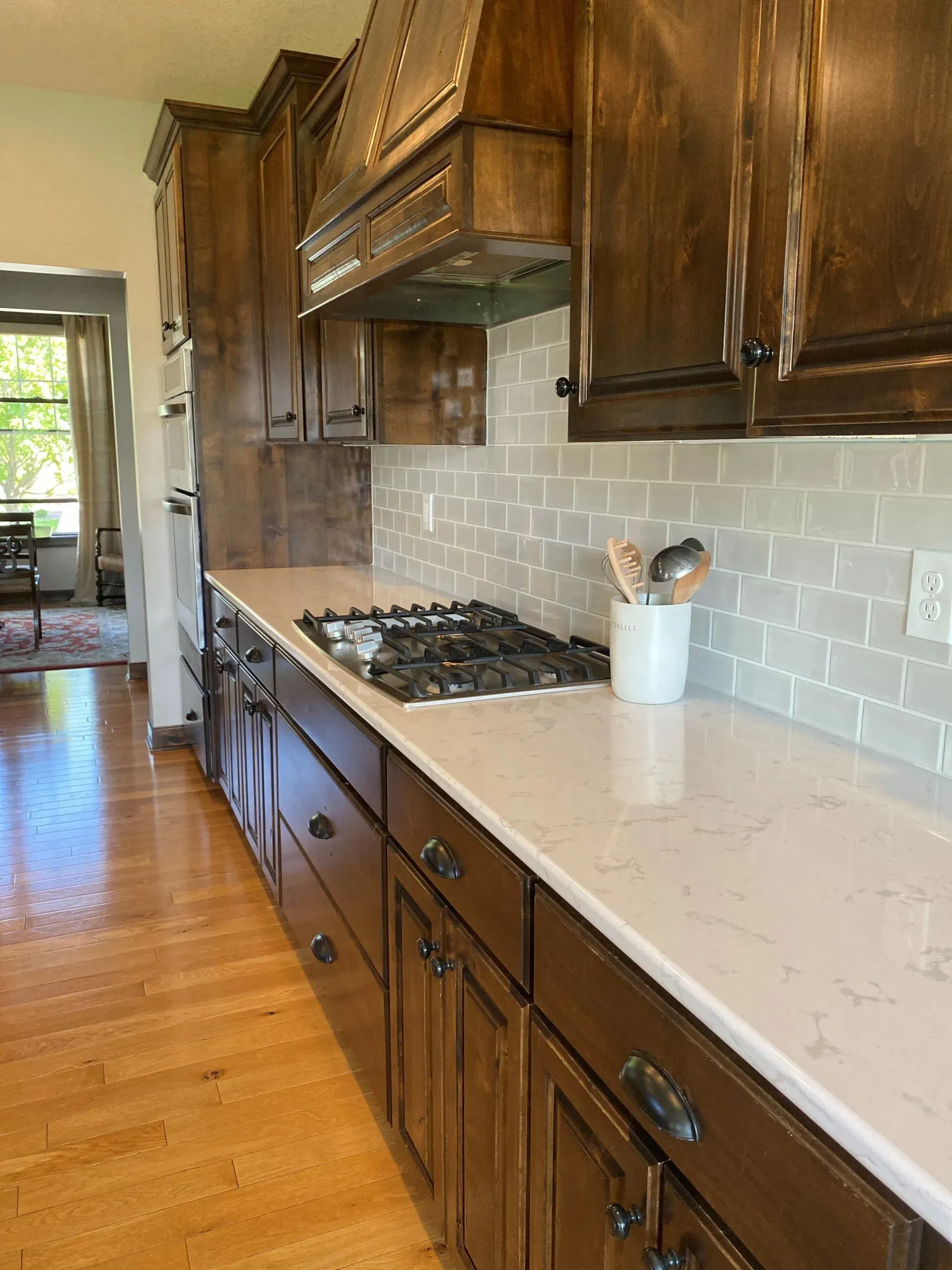 A kitchen with wooden cabinets and a stove top oven.