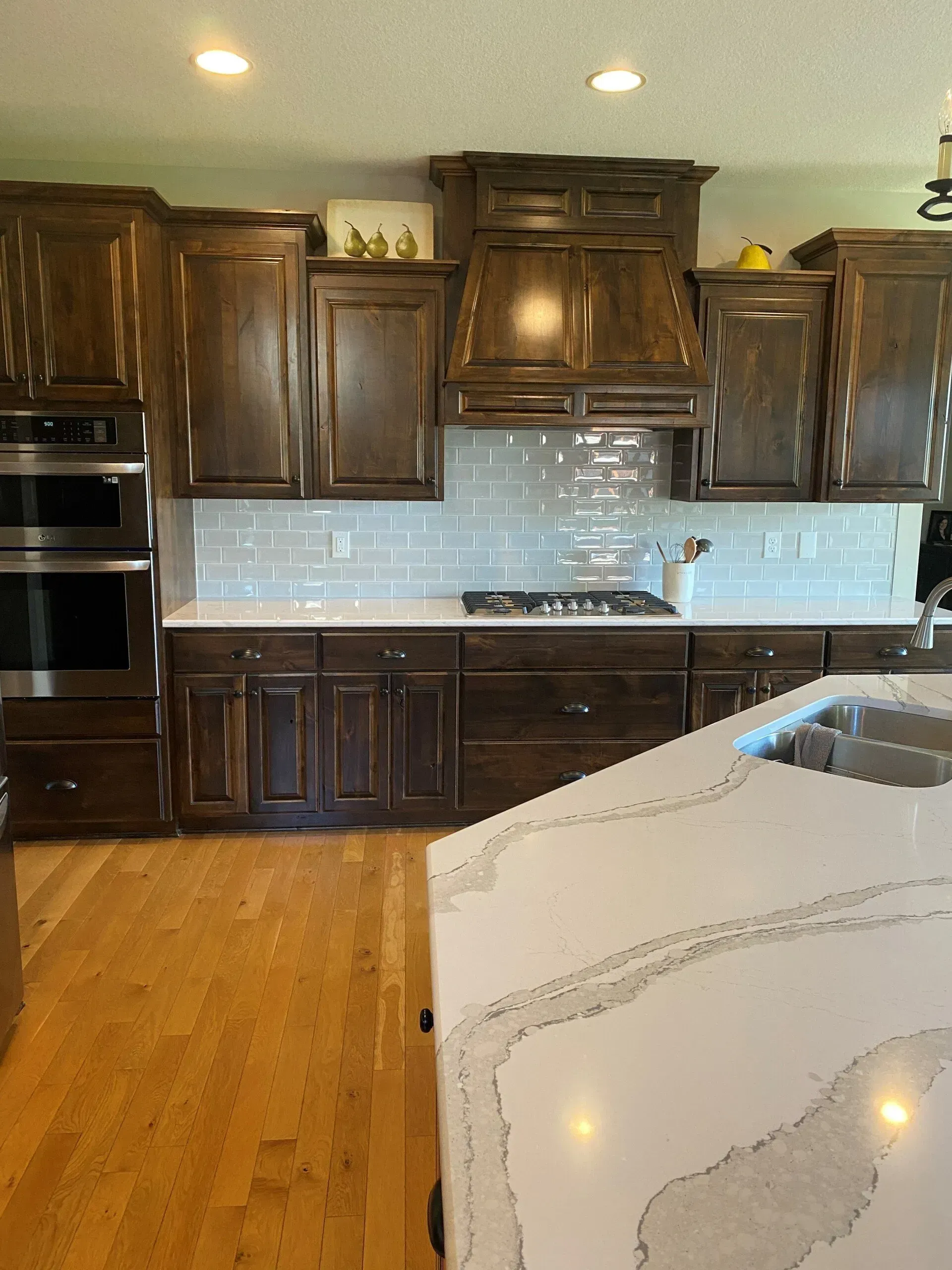 A kitchen with wooden cabinets and stainless steel appliances