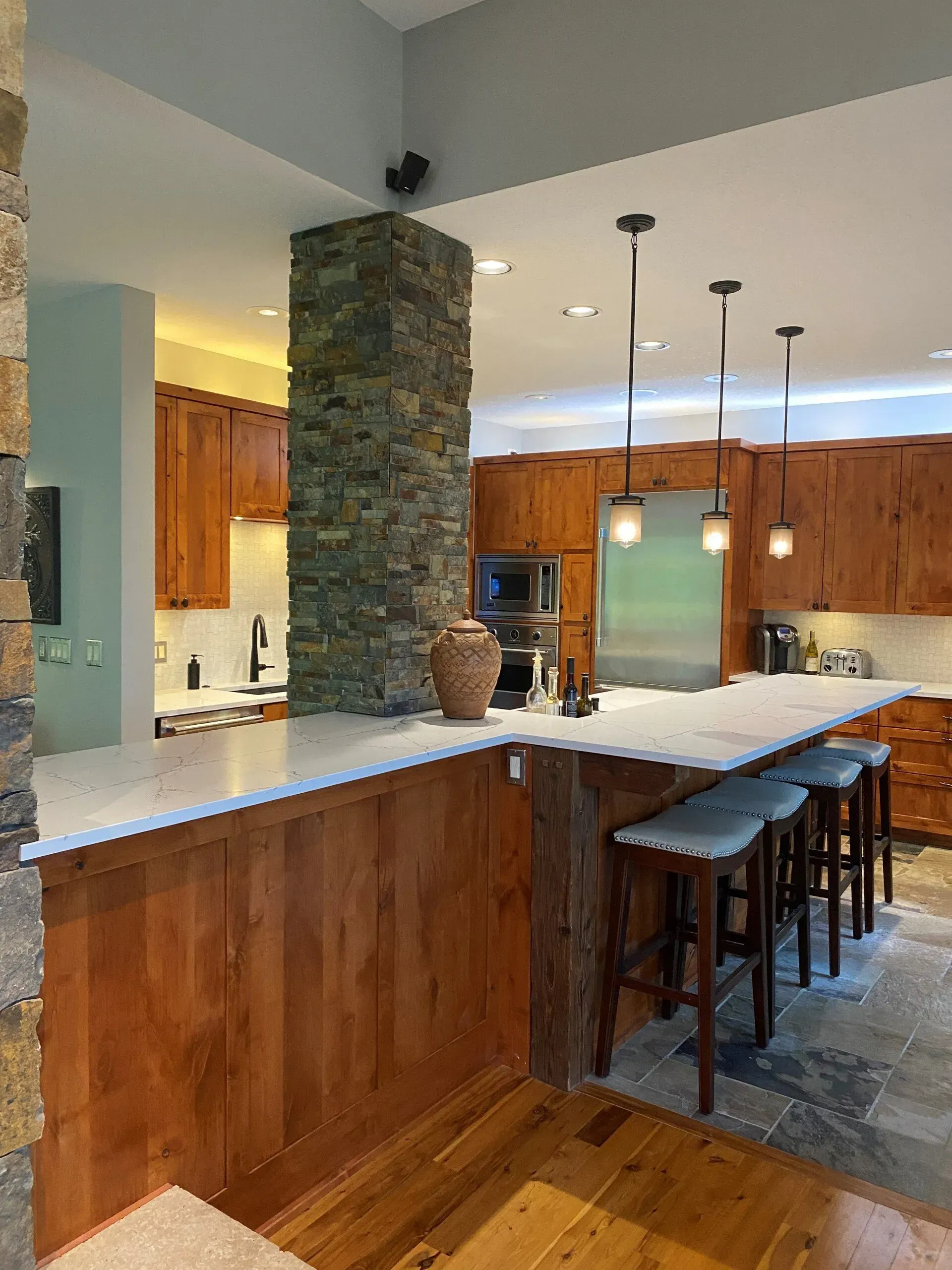 A kitchen with wooden cabinets and stainless steel appliances