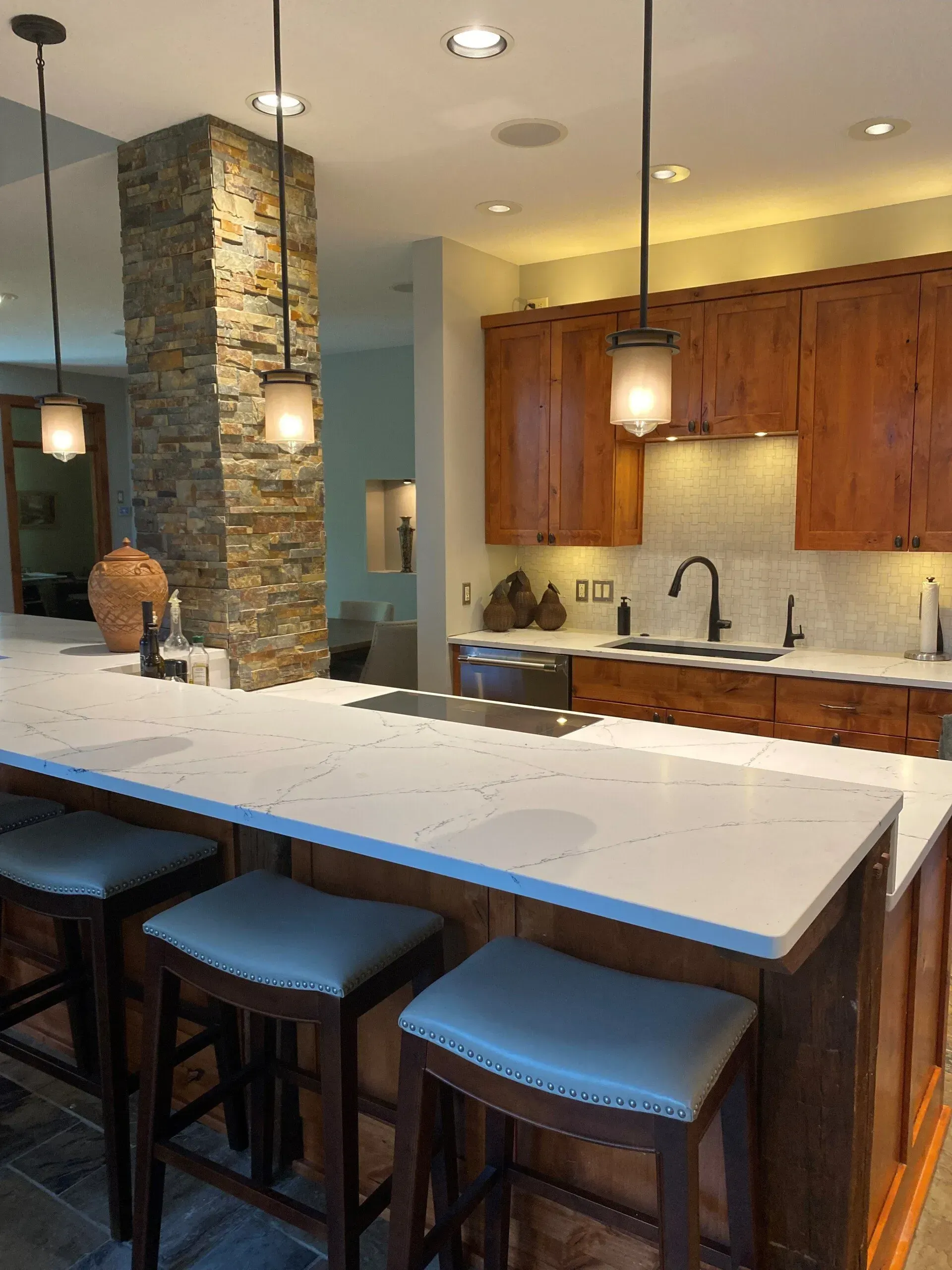 A kitchen with a large island and stools
